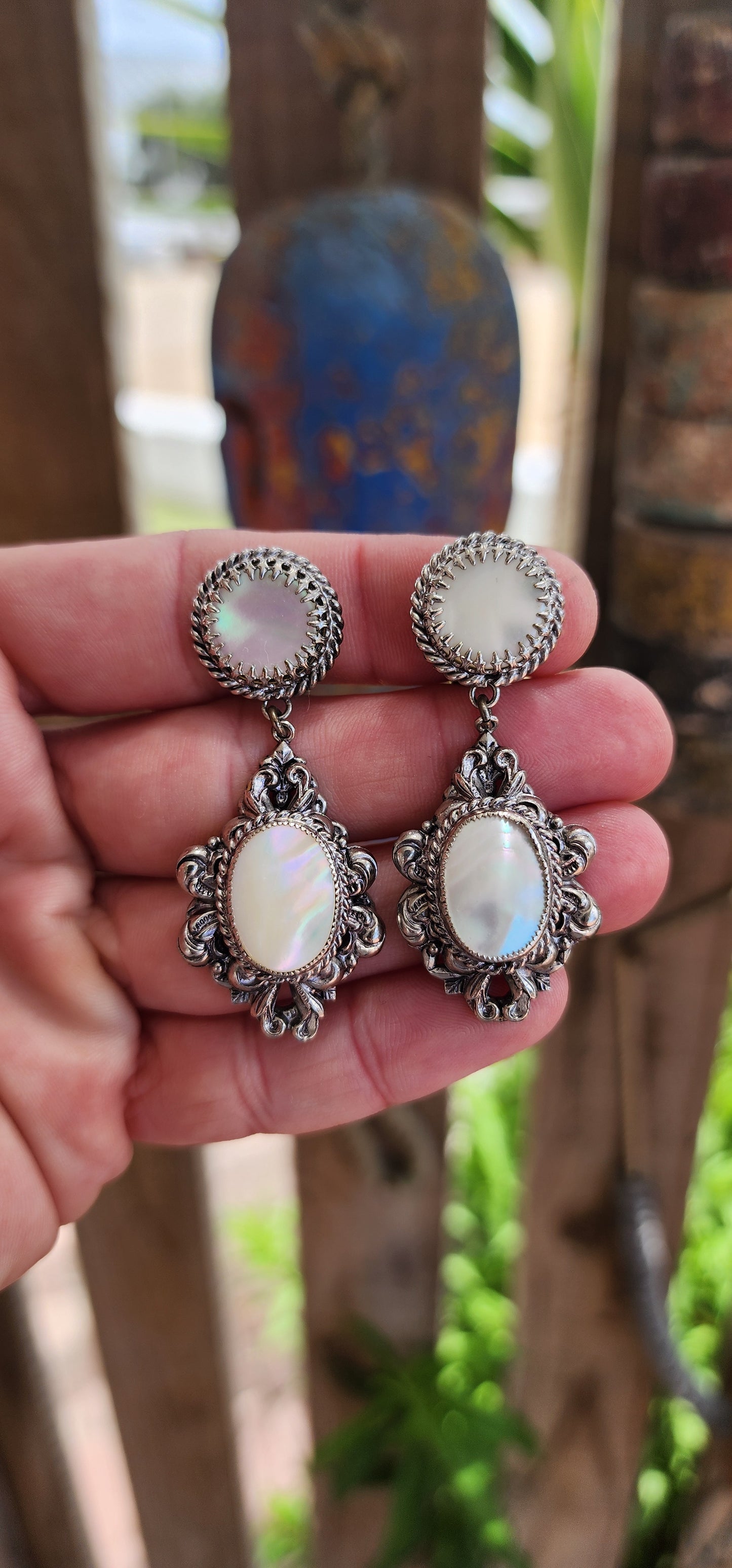 These are beautiful vintage 1930's art deco era czech chandelier-style clip-on earrings, featuring a two-tiered construction, allowing graceful movement between the fixed top and the dangling lower element.