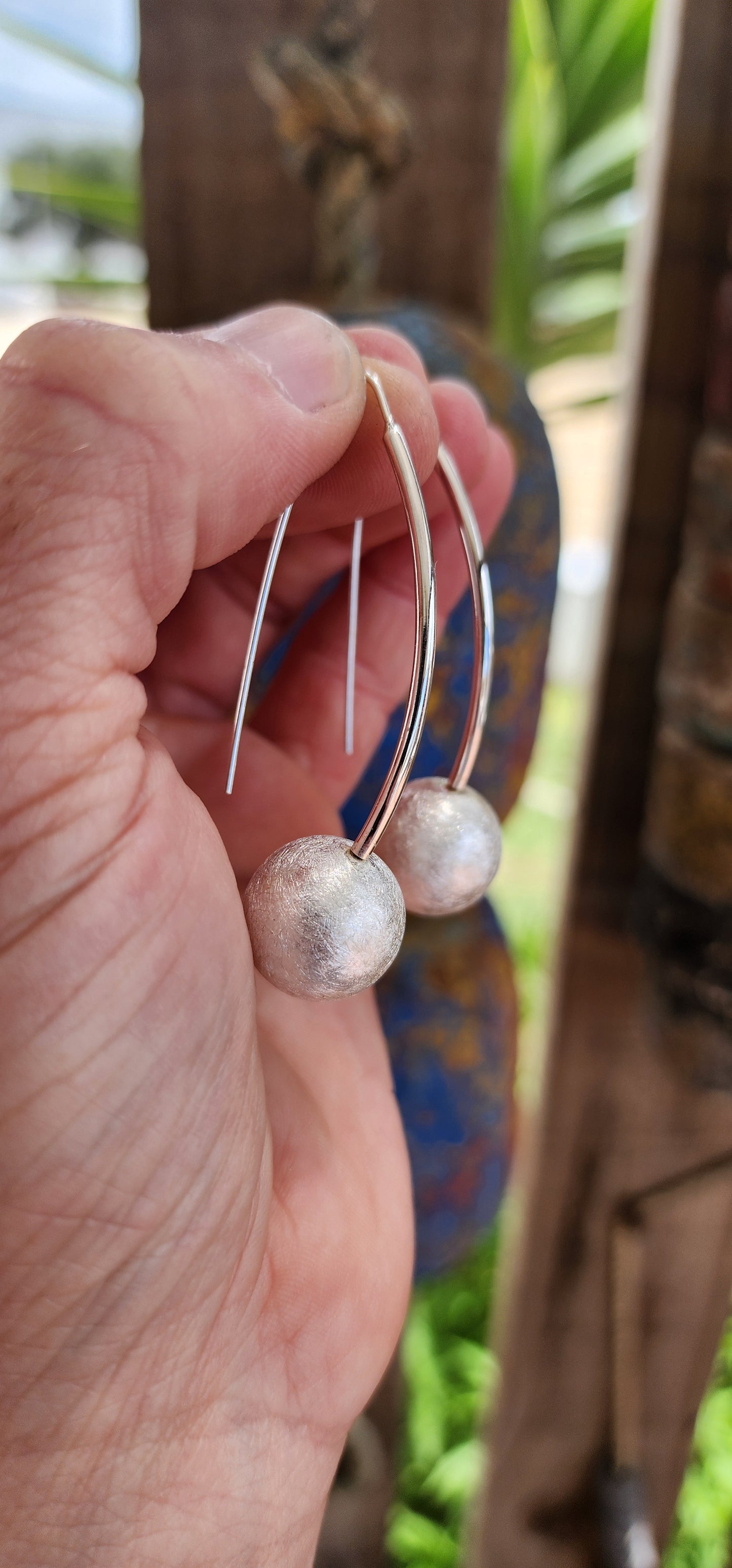 These large sterling silver earrings are a stunning example of modernist design, blending sculptural artistry with a playful, organic twist.