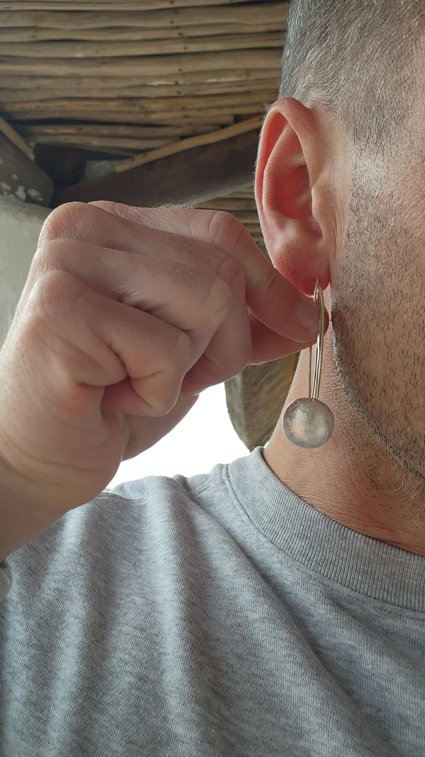 These large sterling silver earrings are a stunning example of modernist design, blending sculptural artistry with a playful, organic twist.