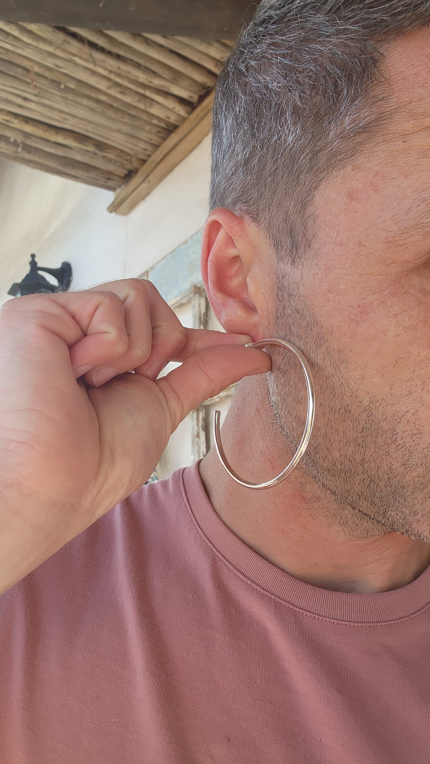 These oversized sterling silver hoop earrings boast a bold, tubular design with a clean and minimalist aesthetic.