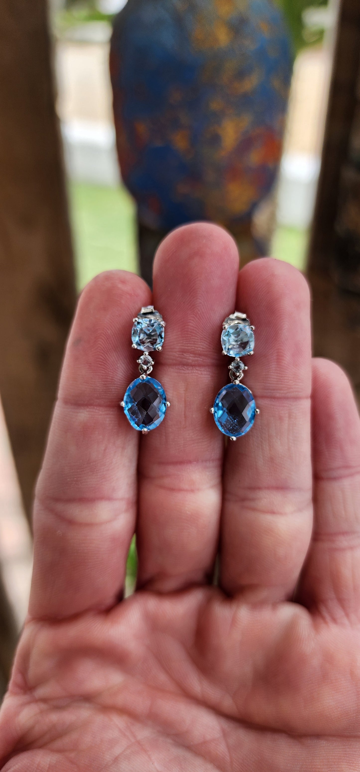 These sterling silver drop earrings are a masterful composition of elegance and radiance, showcasing the breathtaking beauty of blue topaz gemstones.