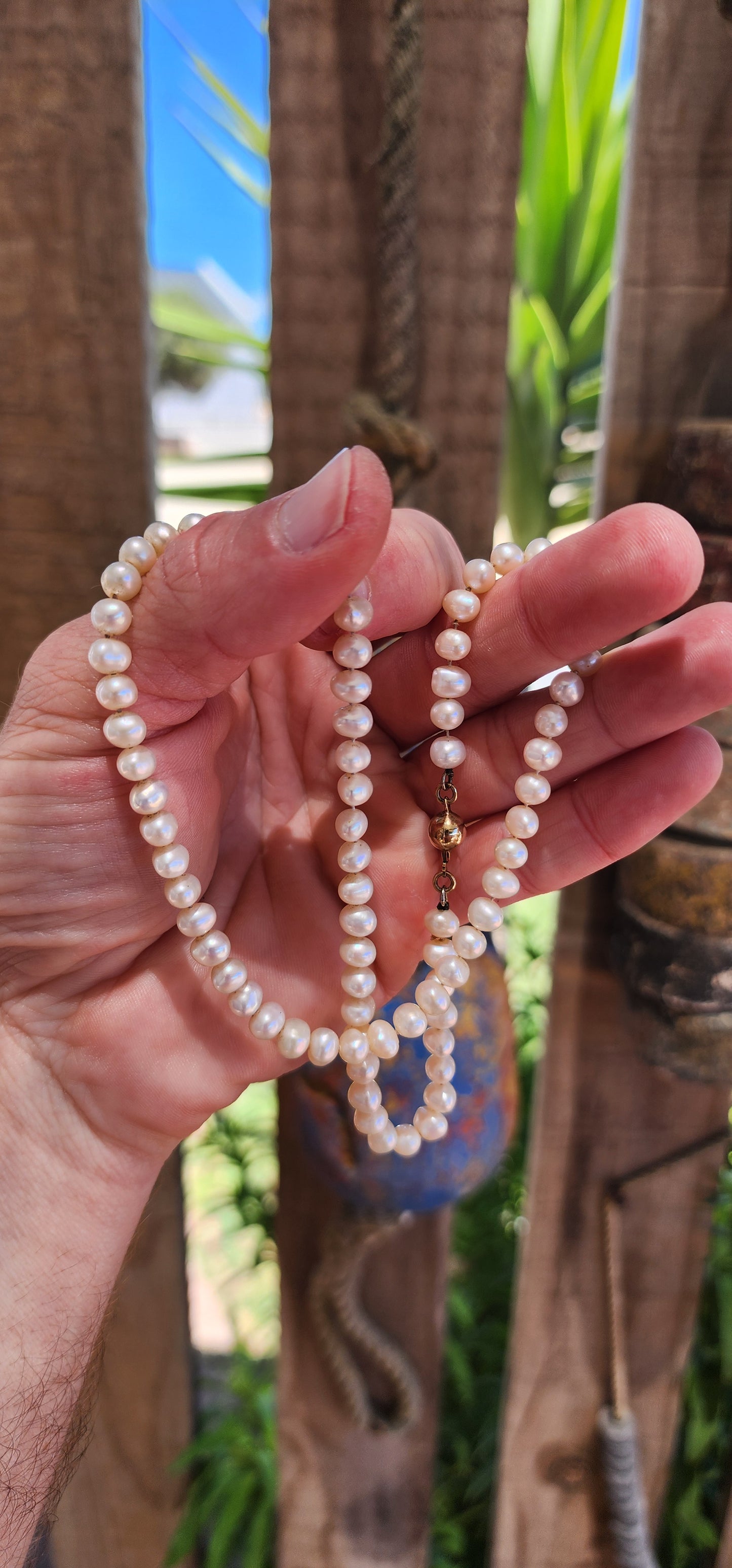 This vintage necklace epitomizes timeless elegance with its single strand of semi-round freshwater pearls.