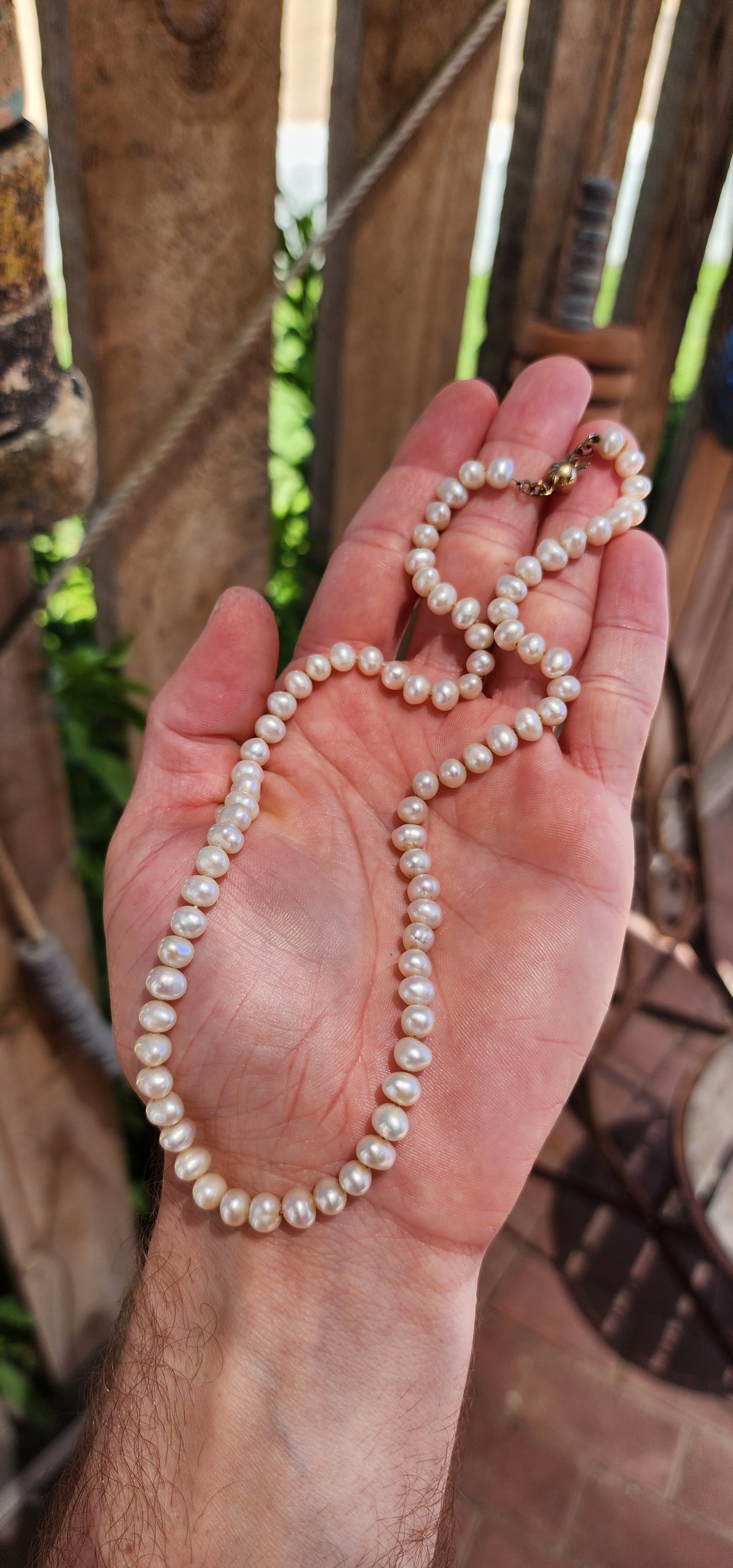 This vintage necklace epitomizes timeless elegance with its single strand of semi-round freshwater pearls.