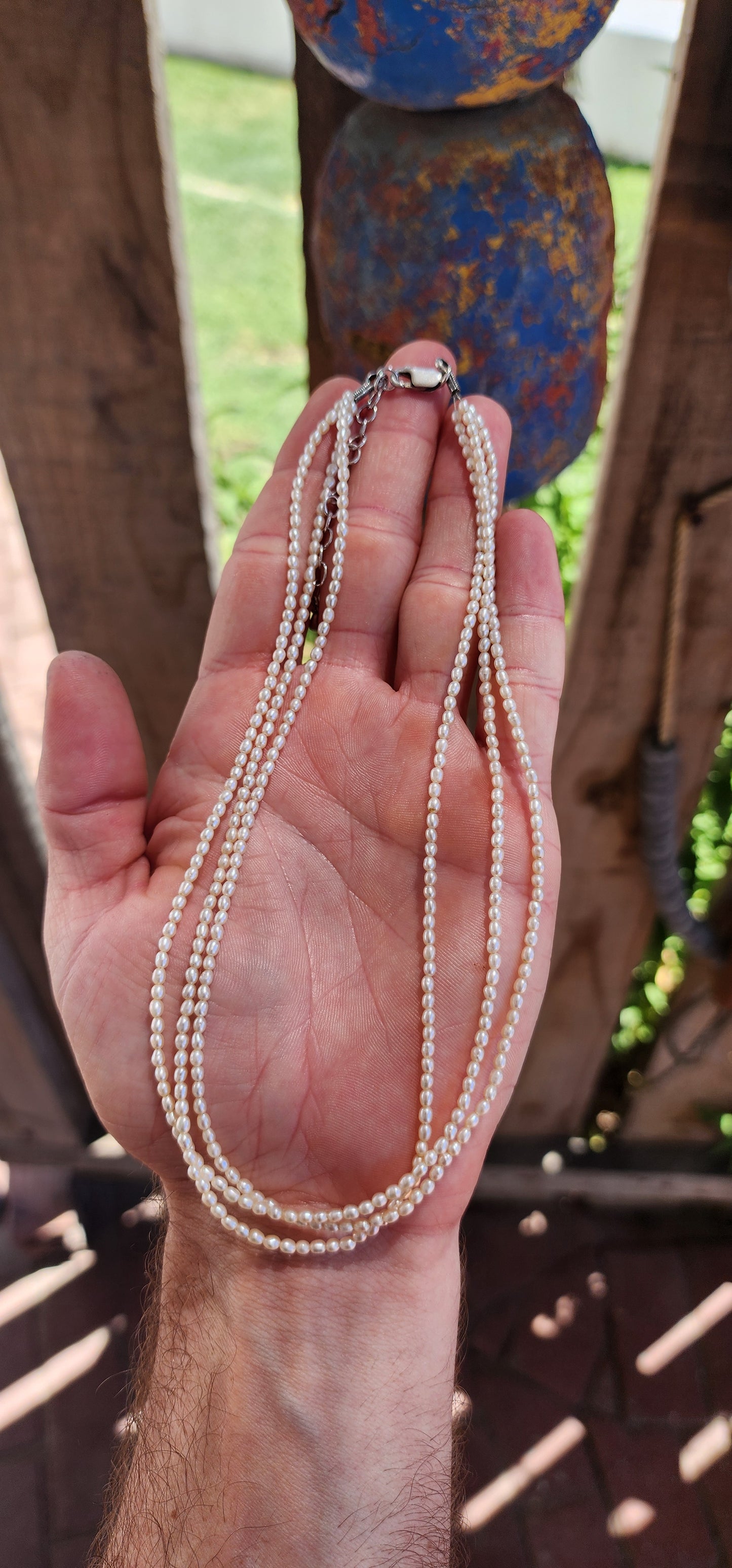 This three-strand necklace of freshwater pearls embodies elegance in its purest form.