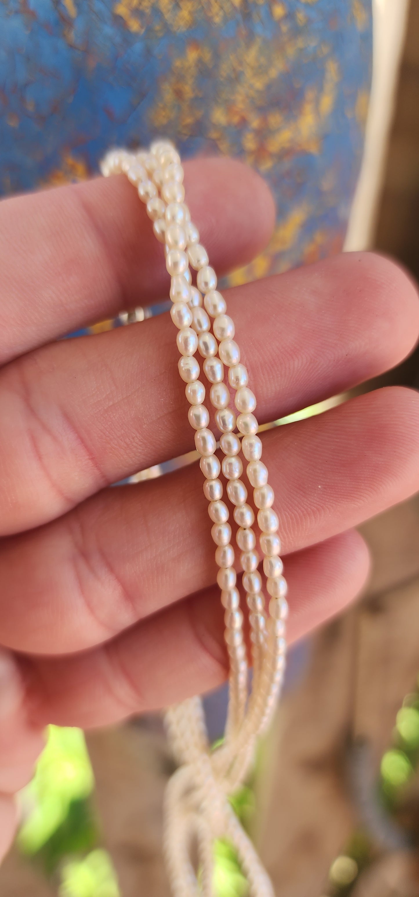 This three-strand necklace of freshwater pearls embodies elegance in its purest form.