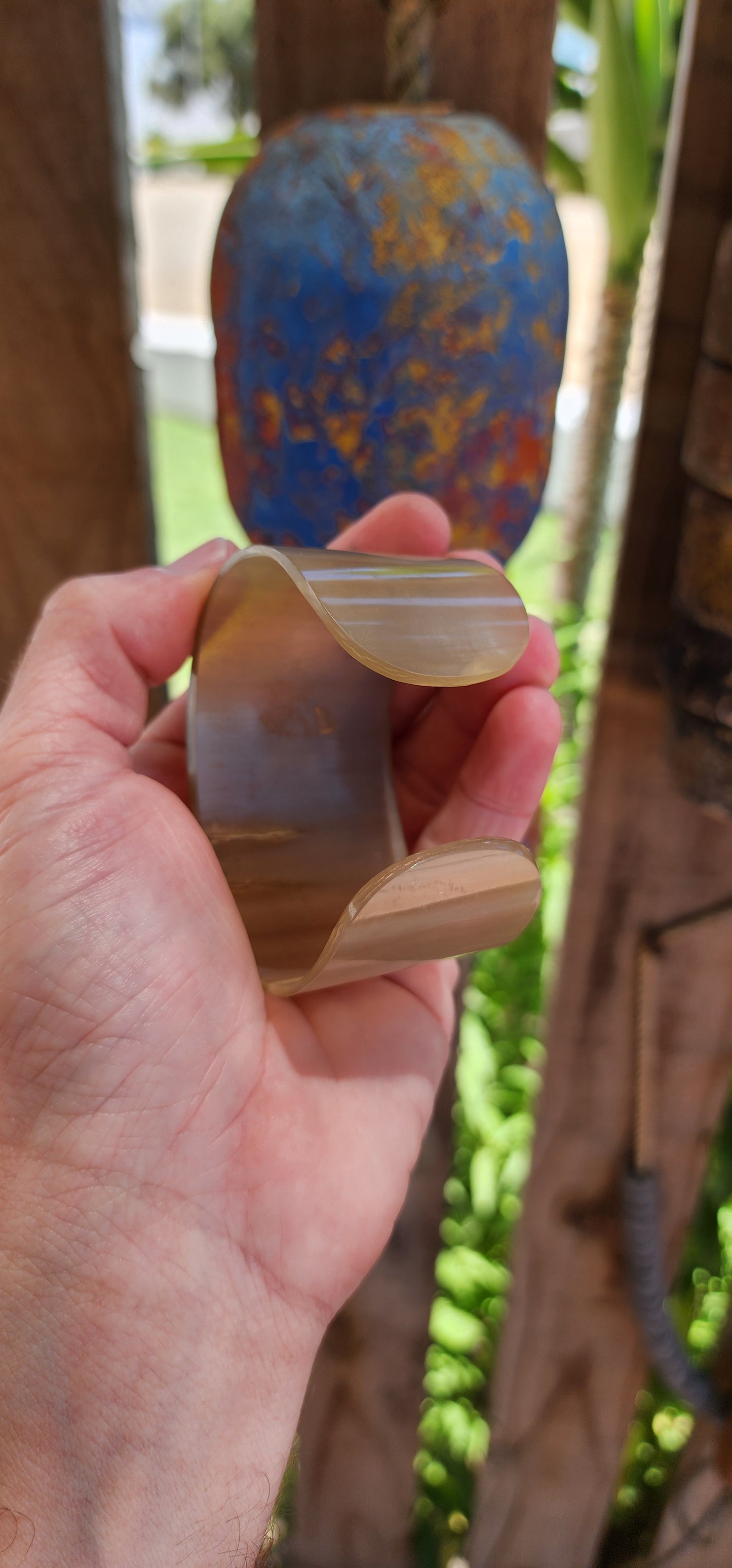 This bold, chunky open cuff bangle is a stunning example of the artistry of hand-carved buffalo horn. Its natural material showcases rich, organic patterns, with earthy tones ranging from deep ebony to warm caramel.