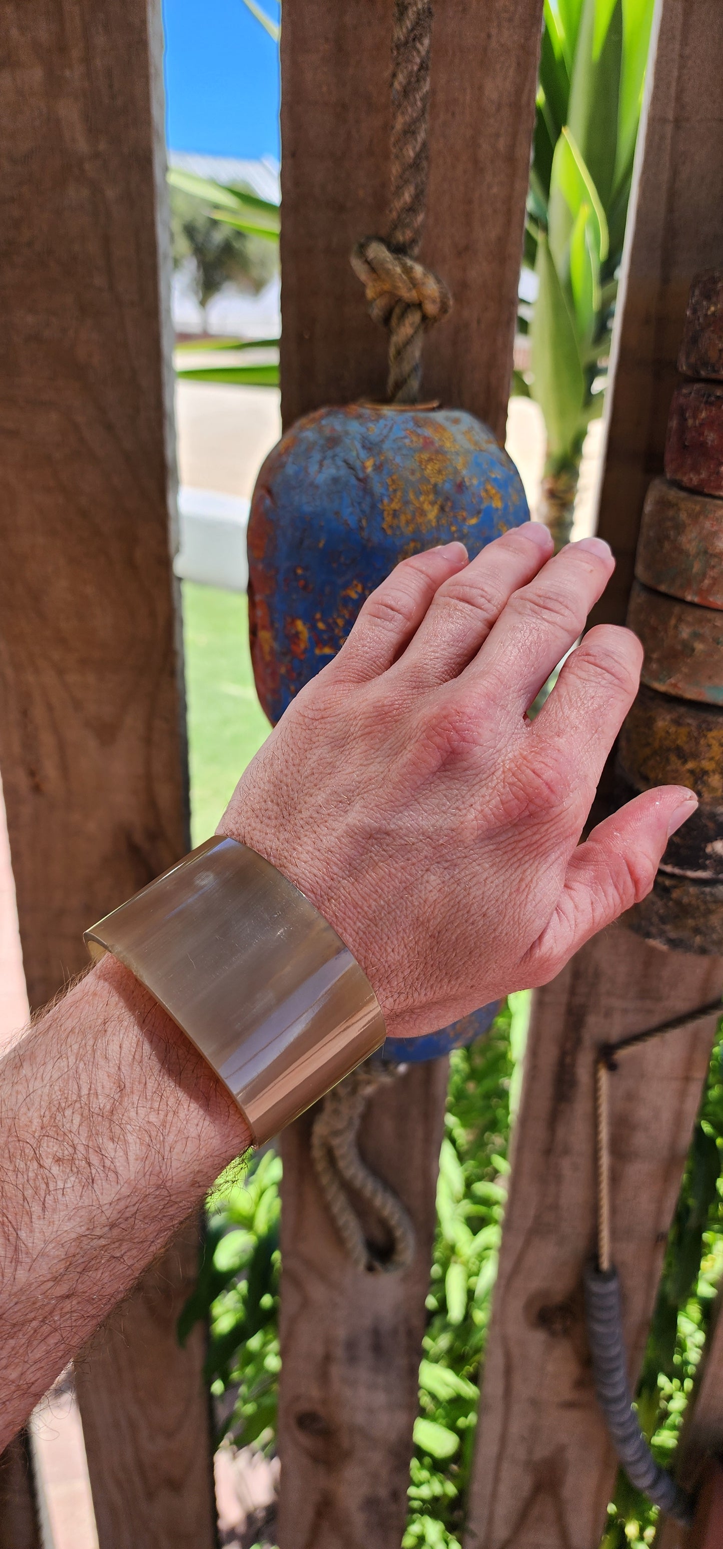 This bold, chunky open cuff bangle is a stunning example of the artistry of hand-carved buffalo horn. Its natural material showcases rich, organic patterns, with earthy tones ranging from deep ebony to warm caramel.