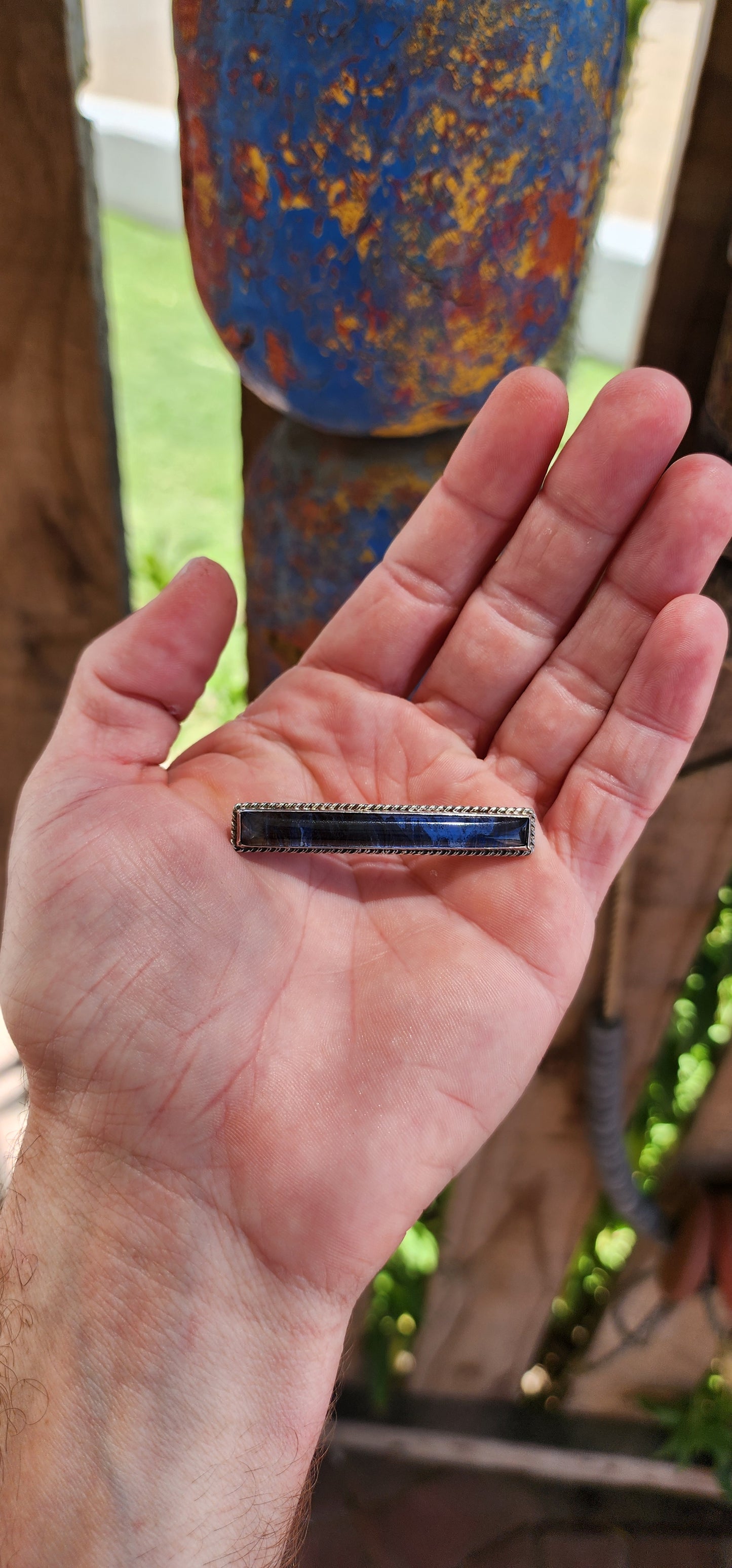 This brooch is a beautiful Art Deco-era piece, dating back to the 1930s. Its slender, rectangular bar design features a convex glass top that protects and magnifies the iridescent natural morpho butterfly wing beneath.