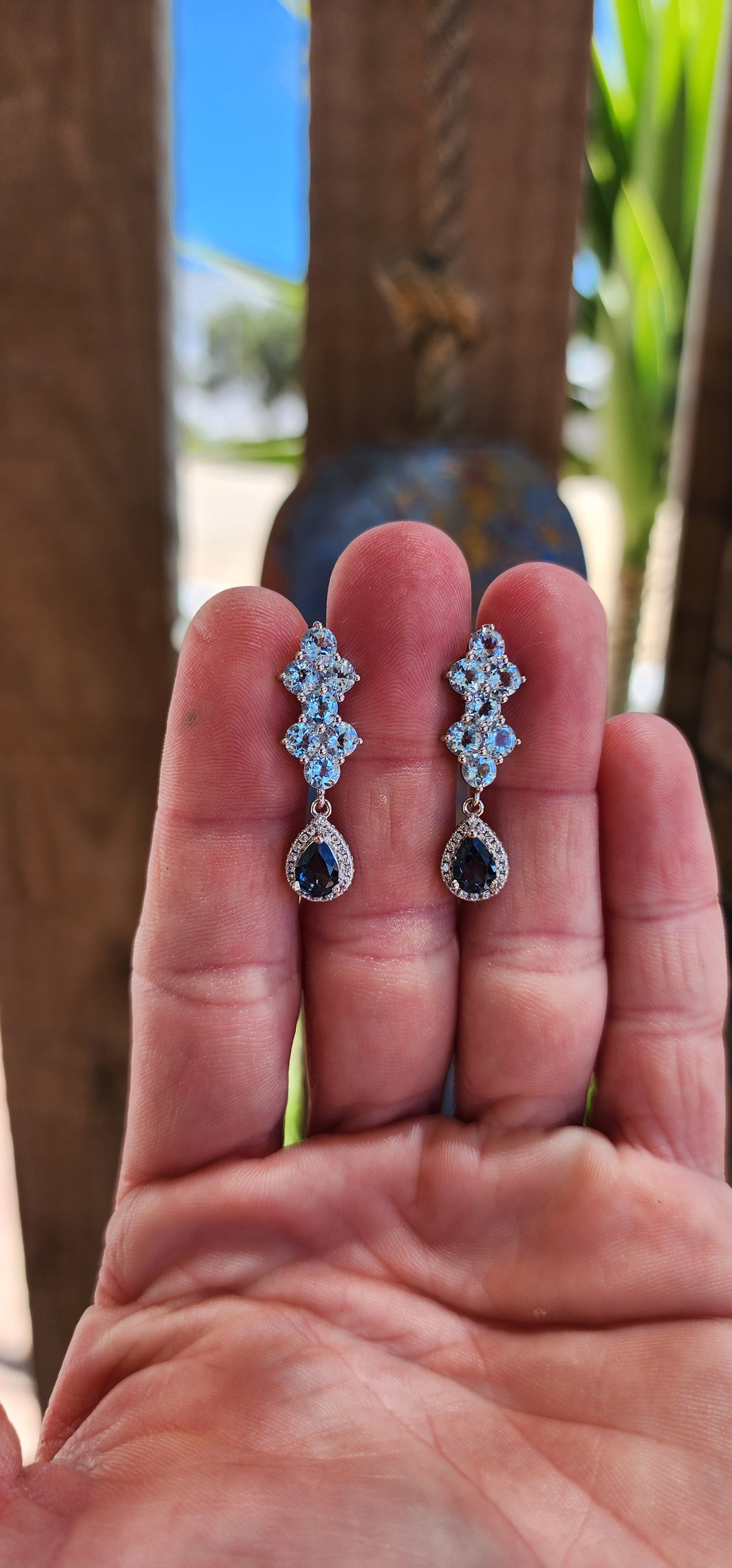 These elegant sterling silver drop earrings are a dazzling celebration of topaz gemstones and expert craftsmanship.