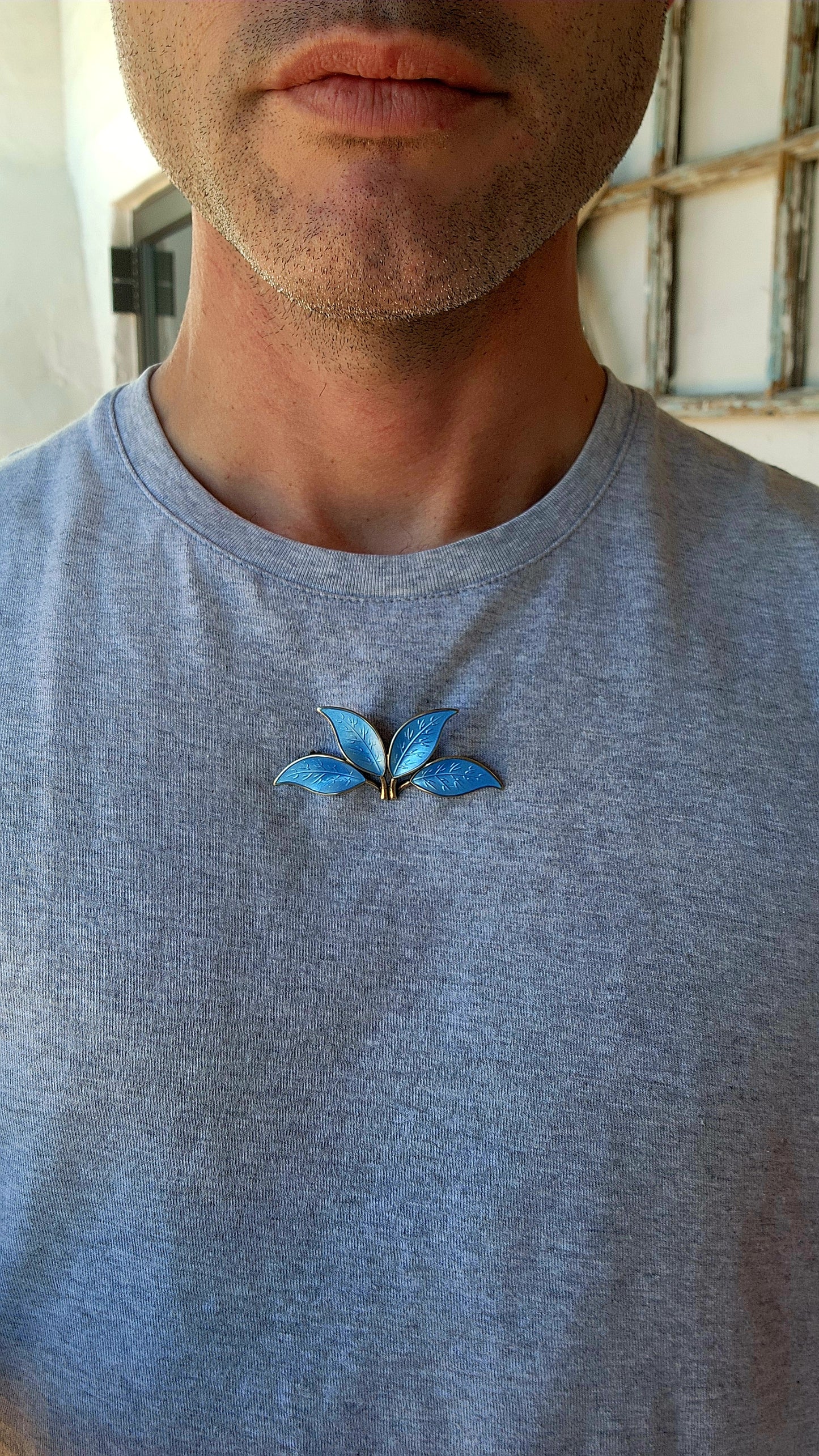 This 1950s Modernist David Andersen/Willy Winnaess sterling silver and blue enamel guilloché leaves brooch is a true masterpiece of Scandinavian design and craftsmanship, embodying the essence of mid-century modernism.