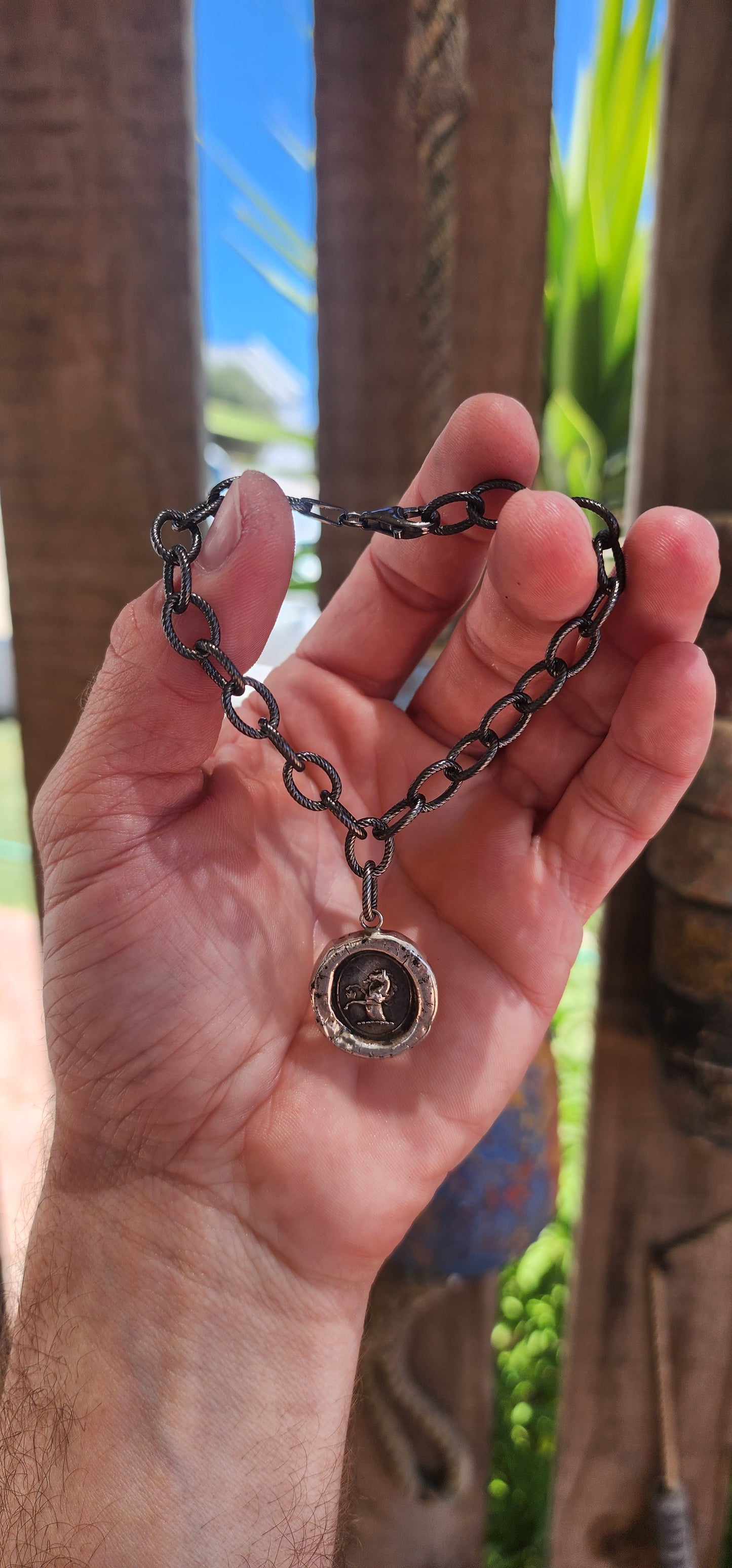 This artisan-crafted sterling silver bracelet with heraldic wax seal pendant is a wearable work of art, steeped in historical charm and symbolic meaning.