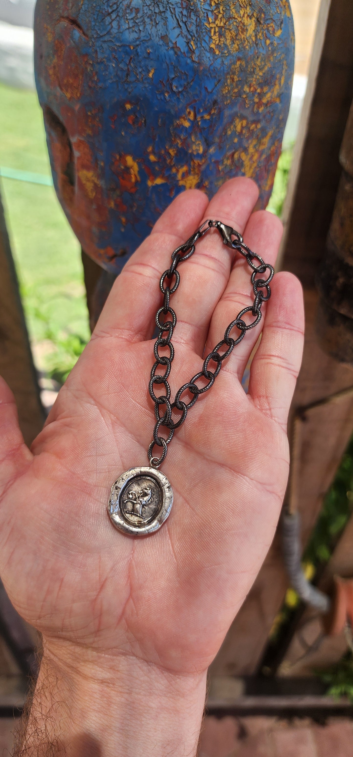 This artisan-crafted sterling silver bracelet with heraldic wax seal pendant is a wearable work of art, steeped in historical charm and symbolic meaning.