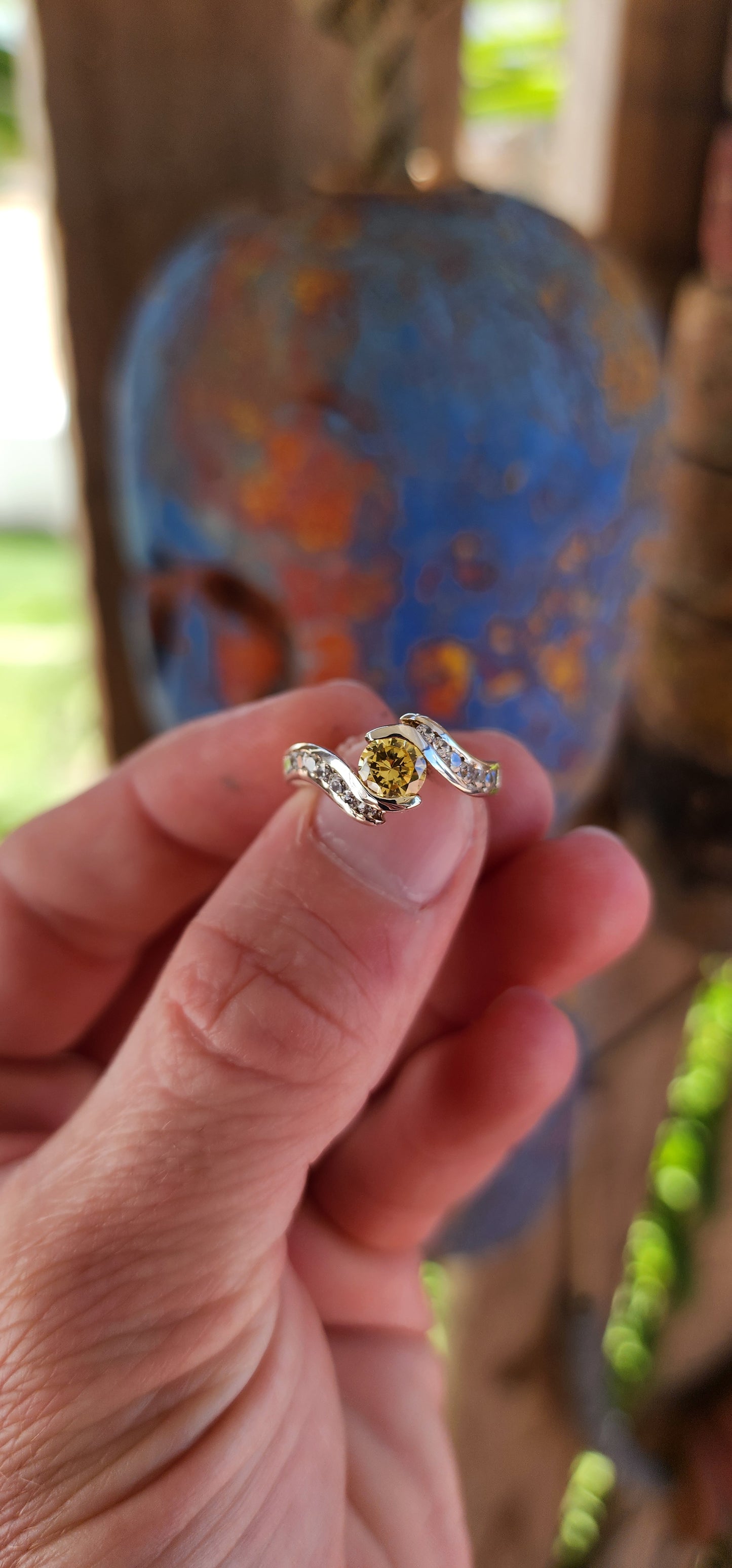 This breathtaking handmade sterling silver ring is a true work of art, seamlessly blending contemporary elegance with timeless beauty. The fluid, sculptural crossover design of the band exudes modernity while maintaining an air of classic refinement.