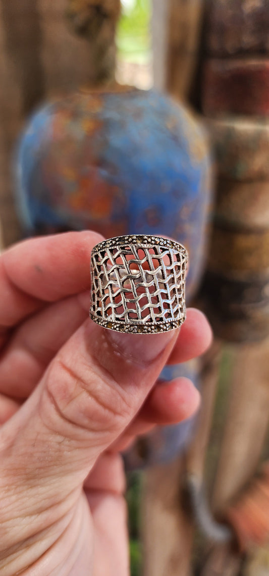 This chunky vintage sterling silver concave dome ring is a statement piece with a story to tell! Its fishnet filigree pierced pattern gives it a delicate, lacy effect while still maintaining a bold and substantial presence.