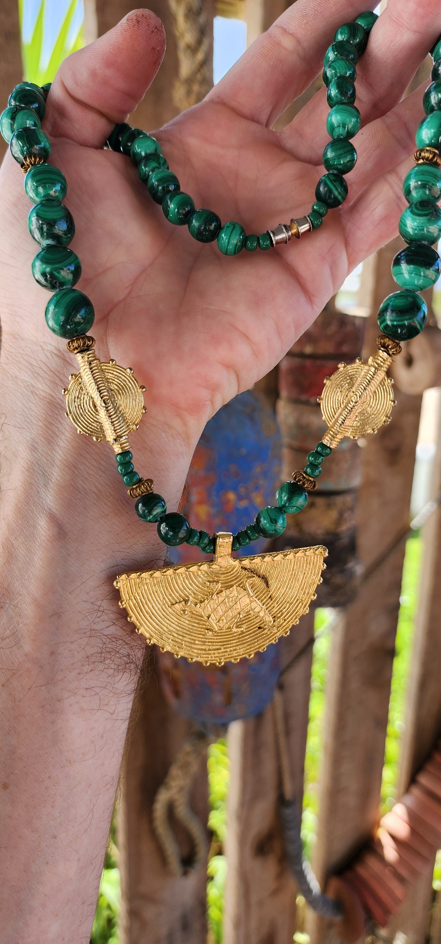 This Ghanaian necklace is a bold and striking piece that beautifully merges natural elegance with African artistry. Featuring highly polished malachite beads, the deep green hues with mesmerizing swirling patterns evoke the rich landscapes of Africa.