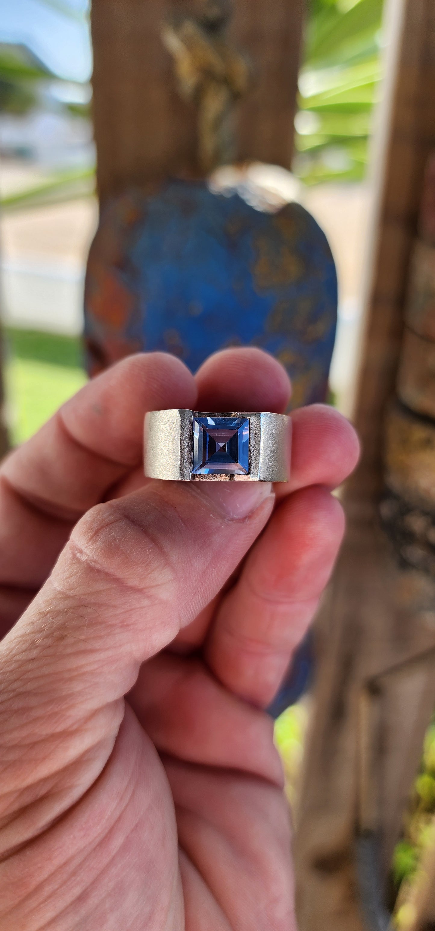 This striking artisan-made unisex statement ring is a bold fusion of modernist design and timeless craftsmanship. Crafted from solid sterling silver, the ring boasts a substantial, weighty presence on the hand, making it an undeniable statement piece.