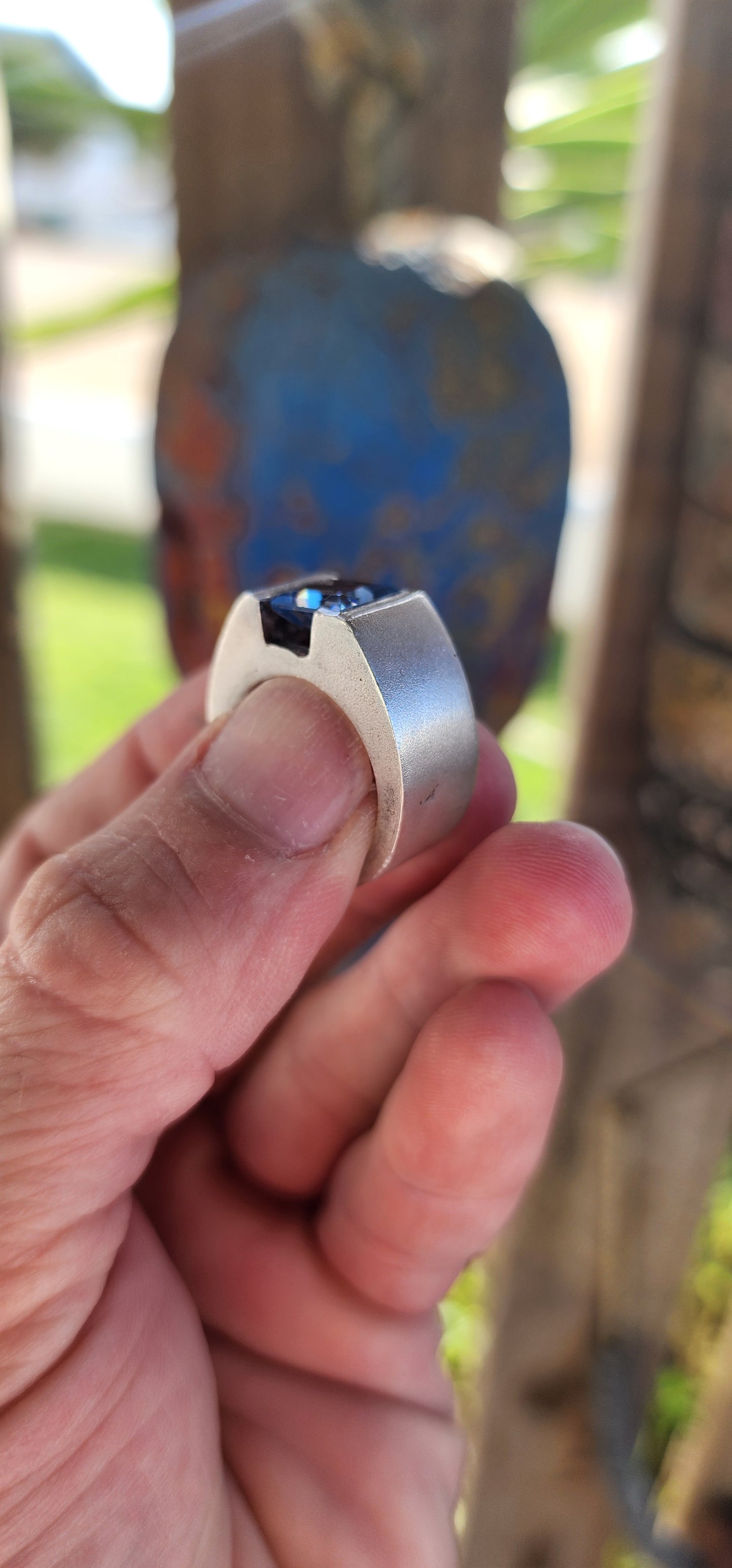 This striking artisan-made unisex statement ring is a bold fusion of modernist design and timeless craftsmanship. Crafted from solid sterling silver, the ring boasts a substantial, weighty presence on the hand, making it an undeniable statement piece.