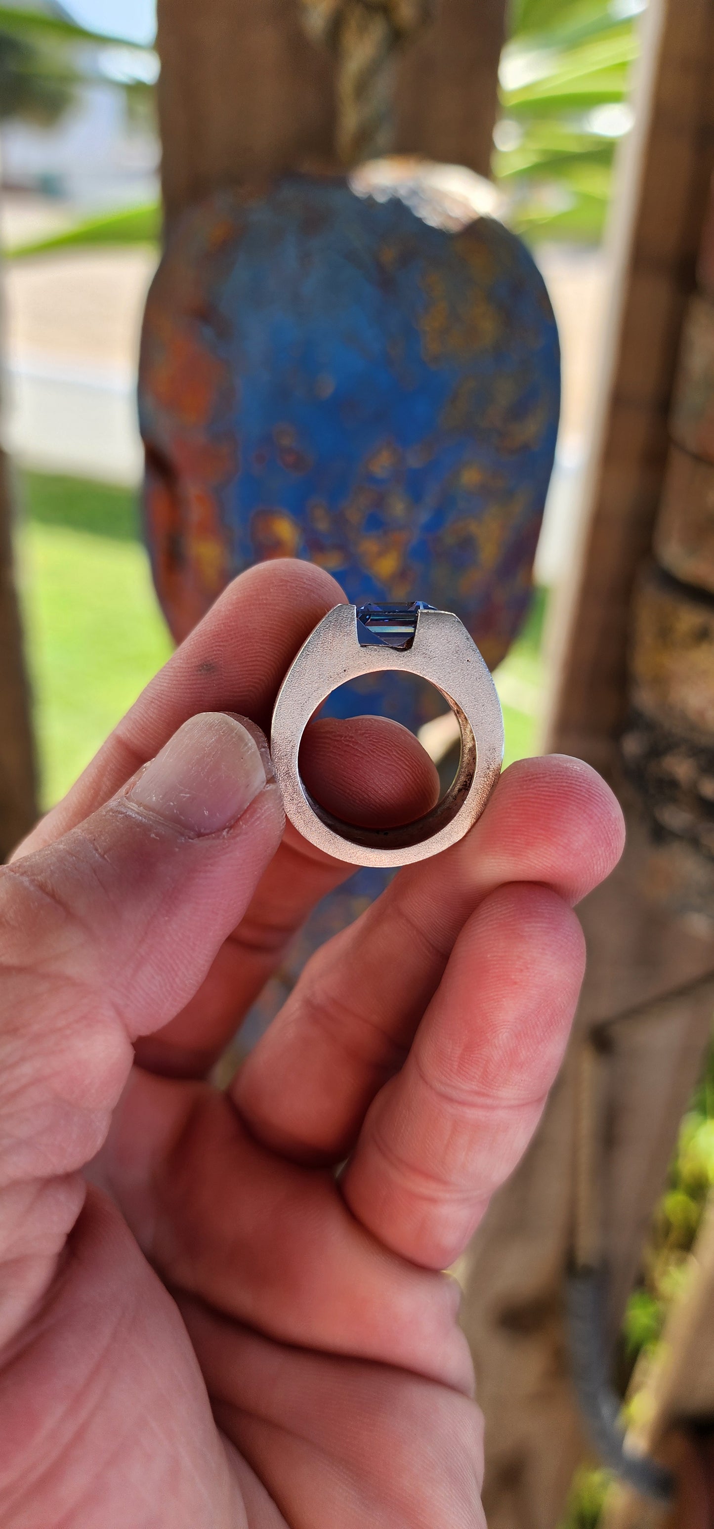 This striking artisan-made unisex statement ring is a bold fusion of modernist design and timeless craftsmanship. Crafted from solid sterling silver, the ring boasts a substantial, weighty presence on the hand, making it an undeniable statement piece.
