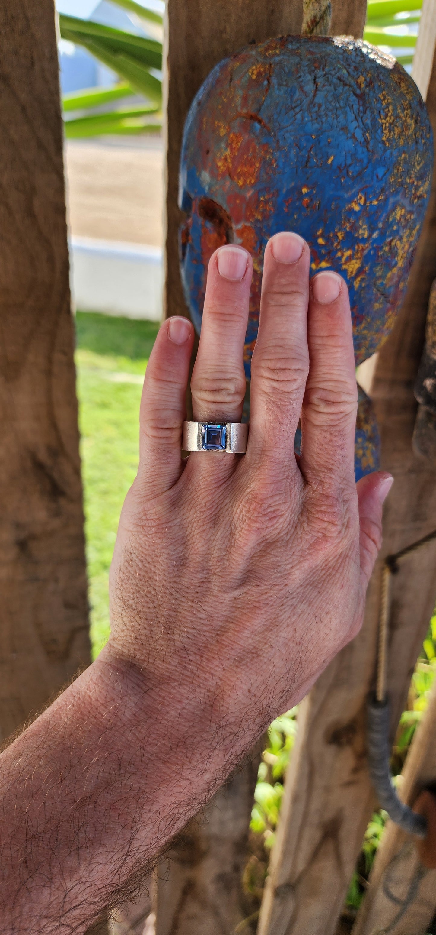 This striking artisan-made unisex statement ring is a bold fusion of modernist design and timeless craftsmanship. Crafted from solid sterling silver, the ring boasts a substantial, weighty presence on the hand, making it an undeniable statement piece.