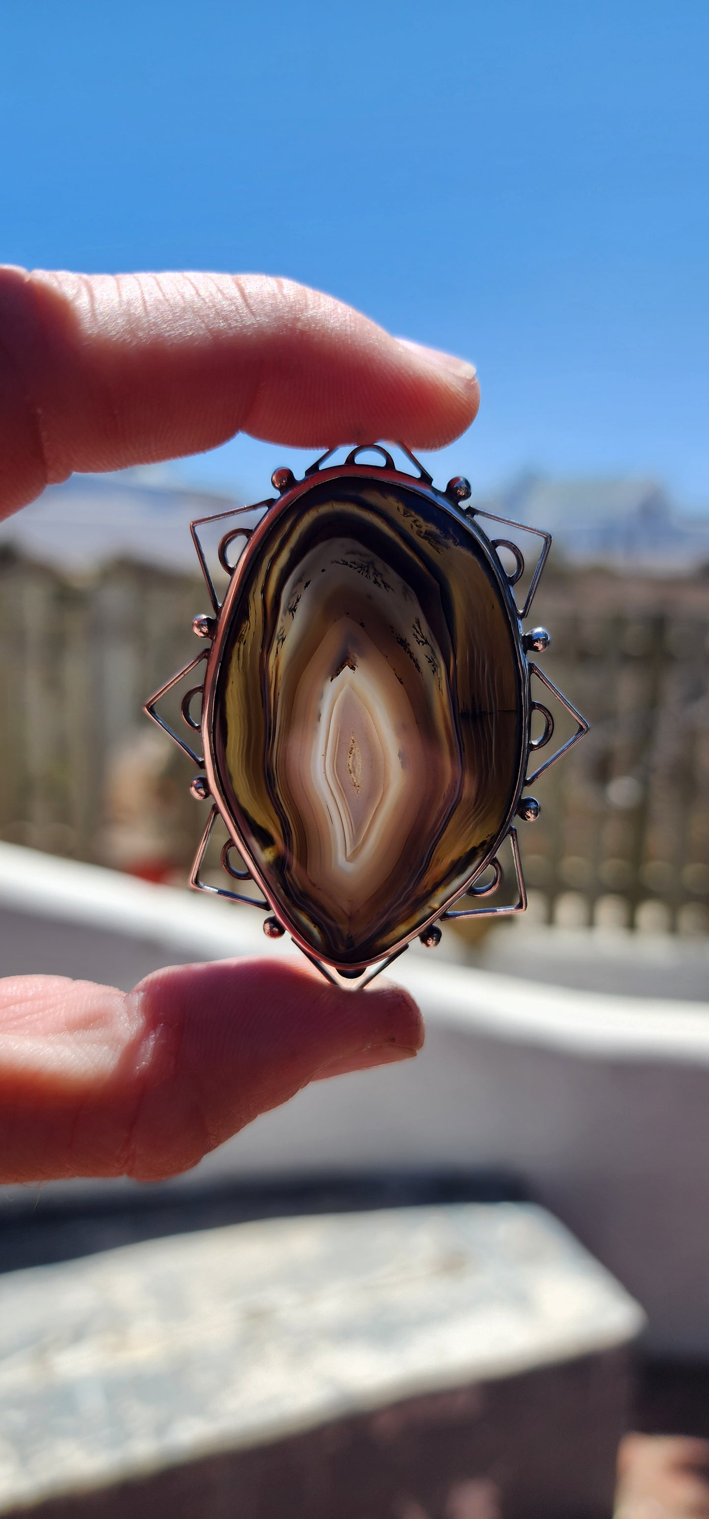 This vintage mid-century sterling silver and banded agate brooch is a true statement piece—bold, earthy, and steeped in artistic craftsmanship.