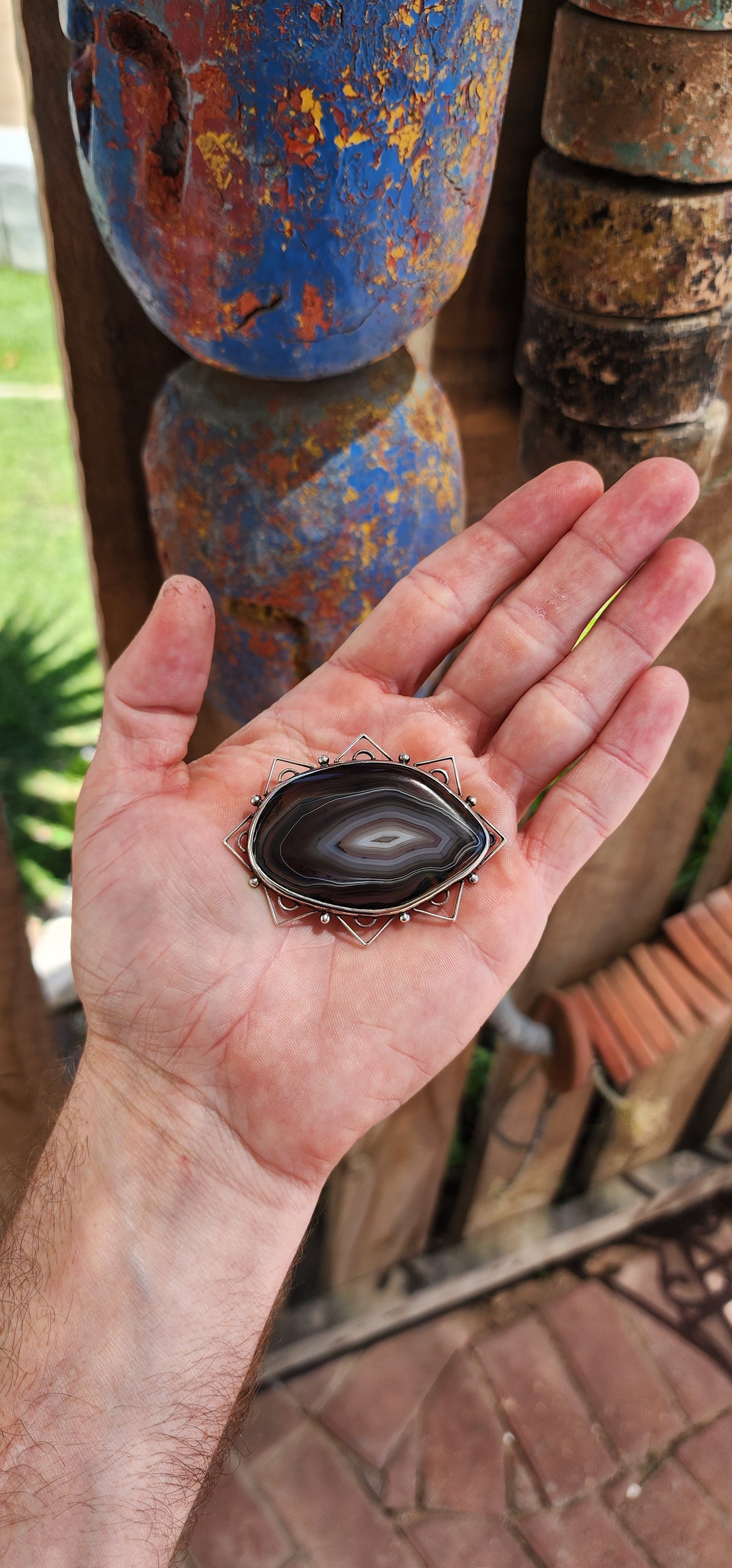 This vintage mid-century sterling silver and banded agate brooch is a true statement piece—bold, earthy, and steeped in artistic craftsmanship.