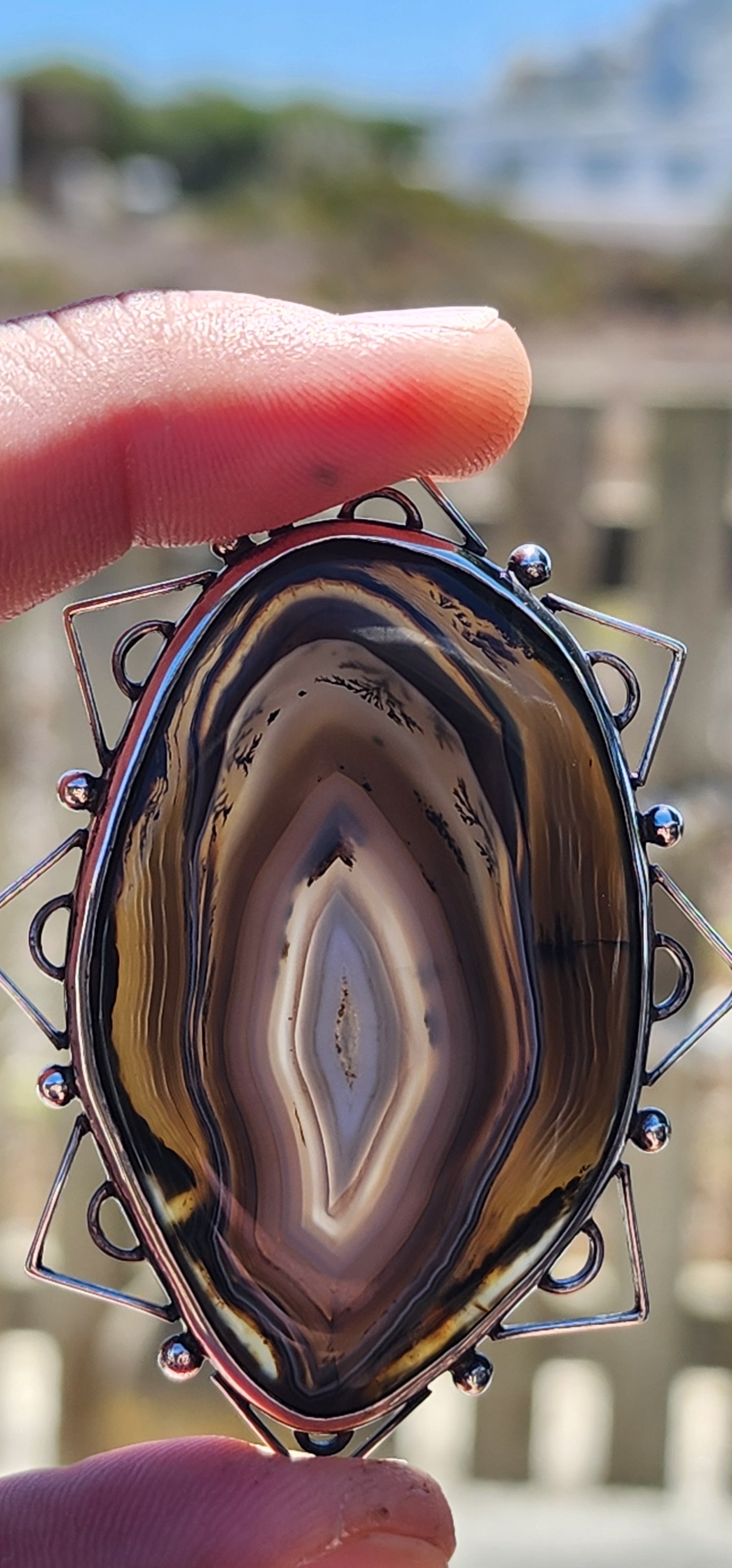 This vintage mid-century sterling silver and banded agate brooch is a true statement piece—bold, earthy, and steeped in artistic craftsmanship.