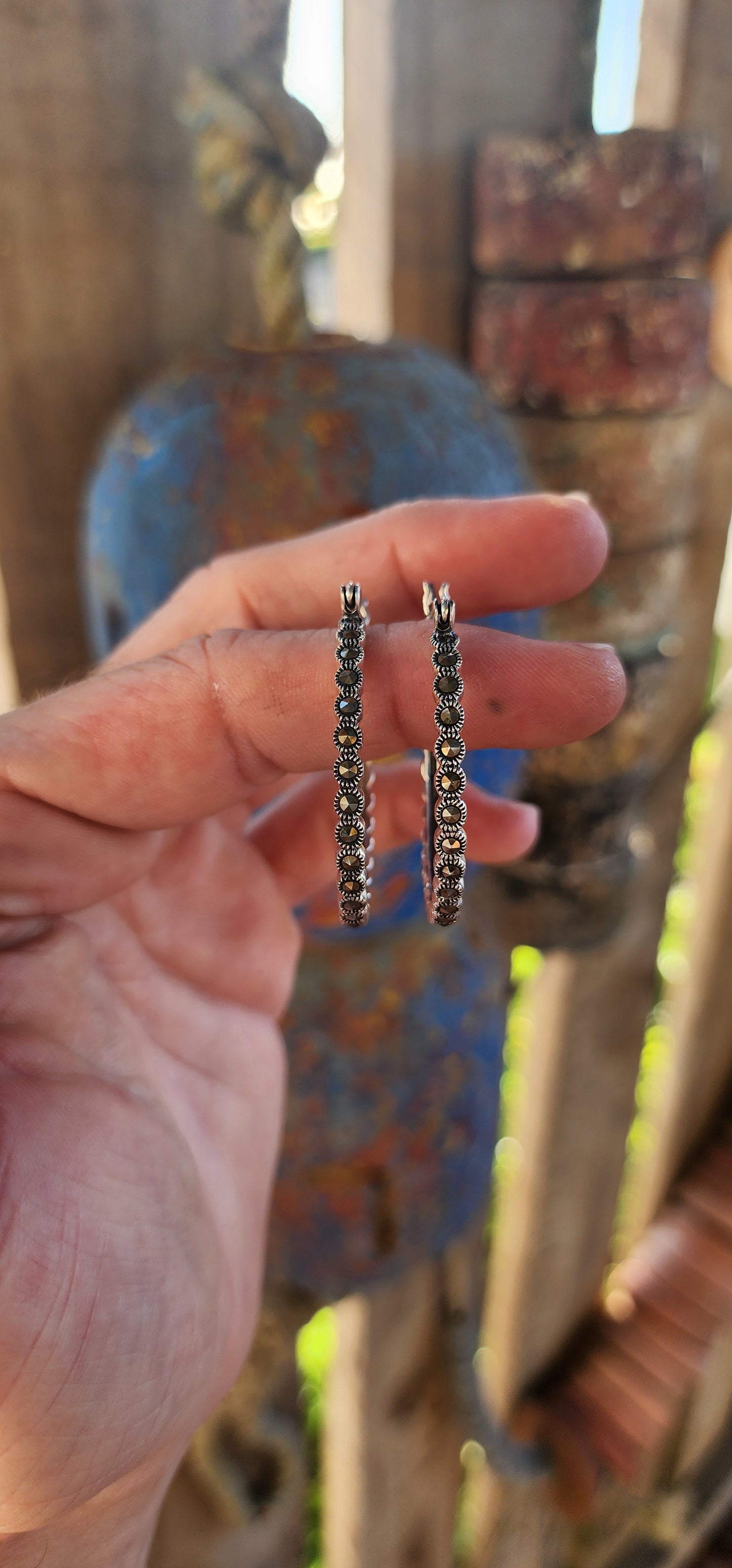 These trusty pair of generous-sized sterling silver hoop earrings are the epitome of vintage-inspired glamour and versatility. These statement hoops are crafted in lustrous sterling silver, exuding a timeless elegance.