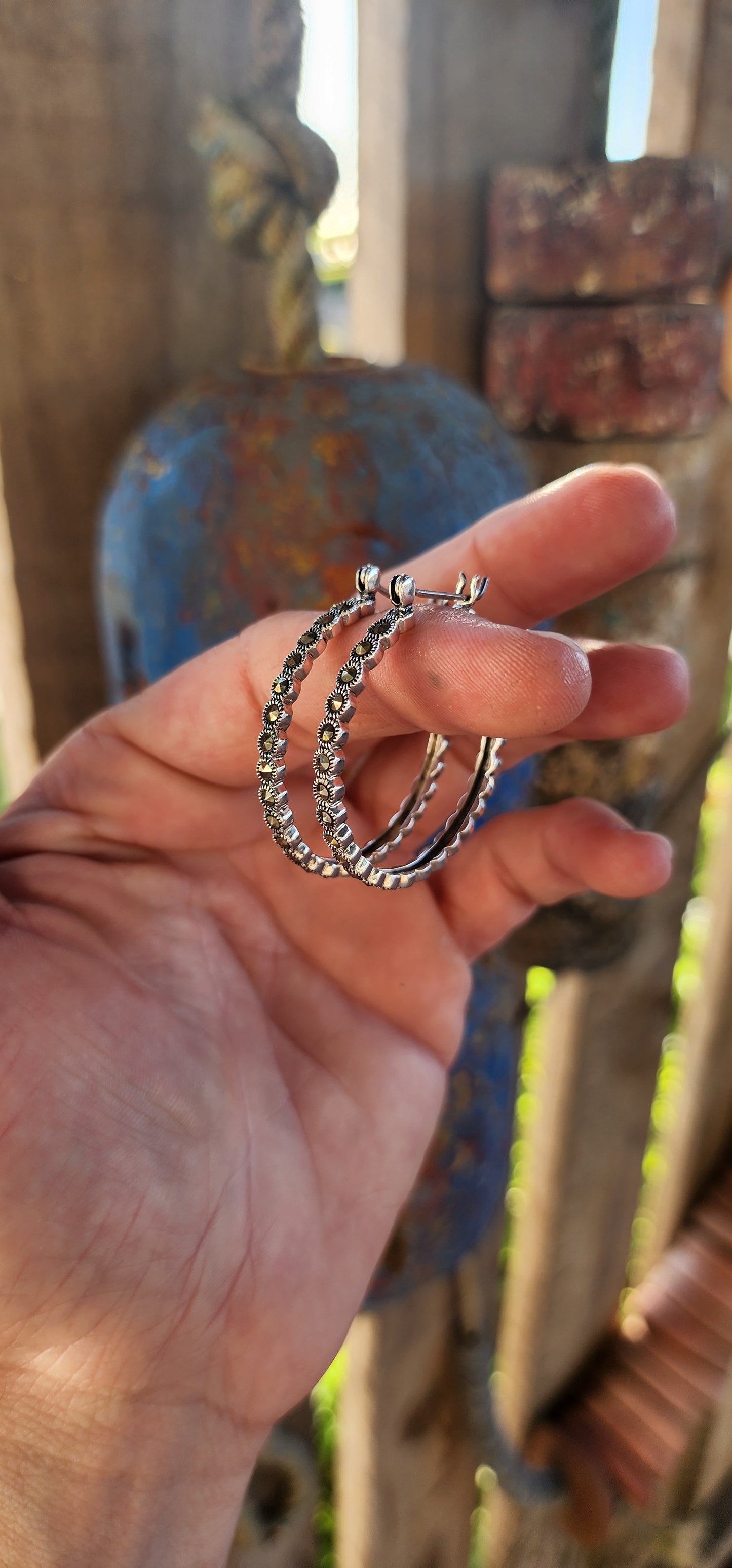 These trusty pair of generous-sized sterling silver hoop earrings are the epitome of vintage-inspired glamour and versatility. These statement hoops are crafted in lustrous sterling silver, exuding a timeless elegance.