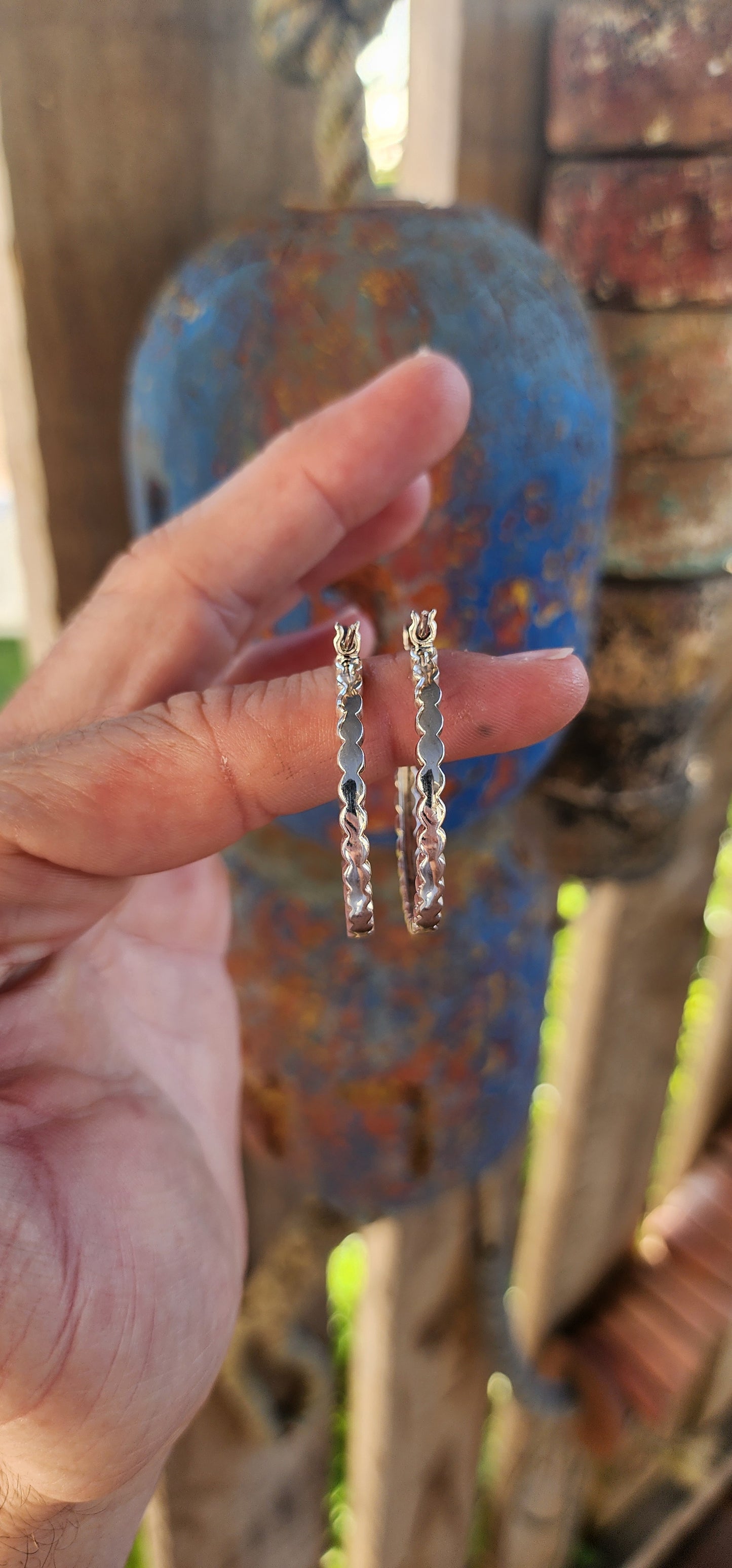These trusty pair of generous-sized sterling silver hoop earrings are the epitome of vintage-inspired glamour and versatility. These statement hoops are crafted in lustrous sterling silver, exuding a timeless elegance.