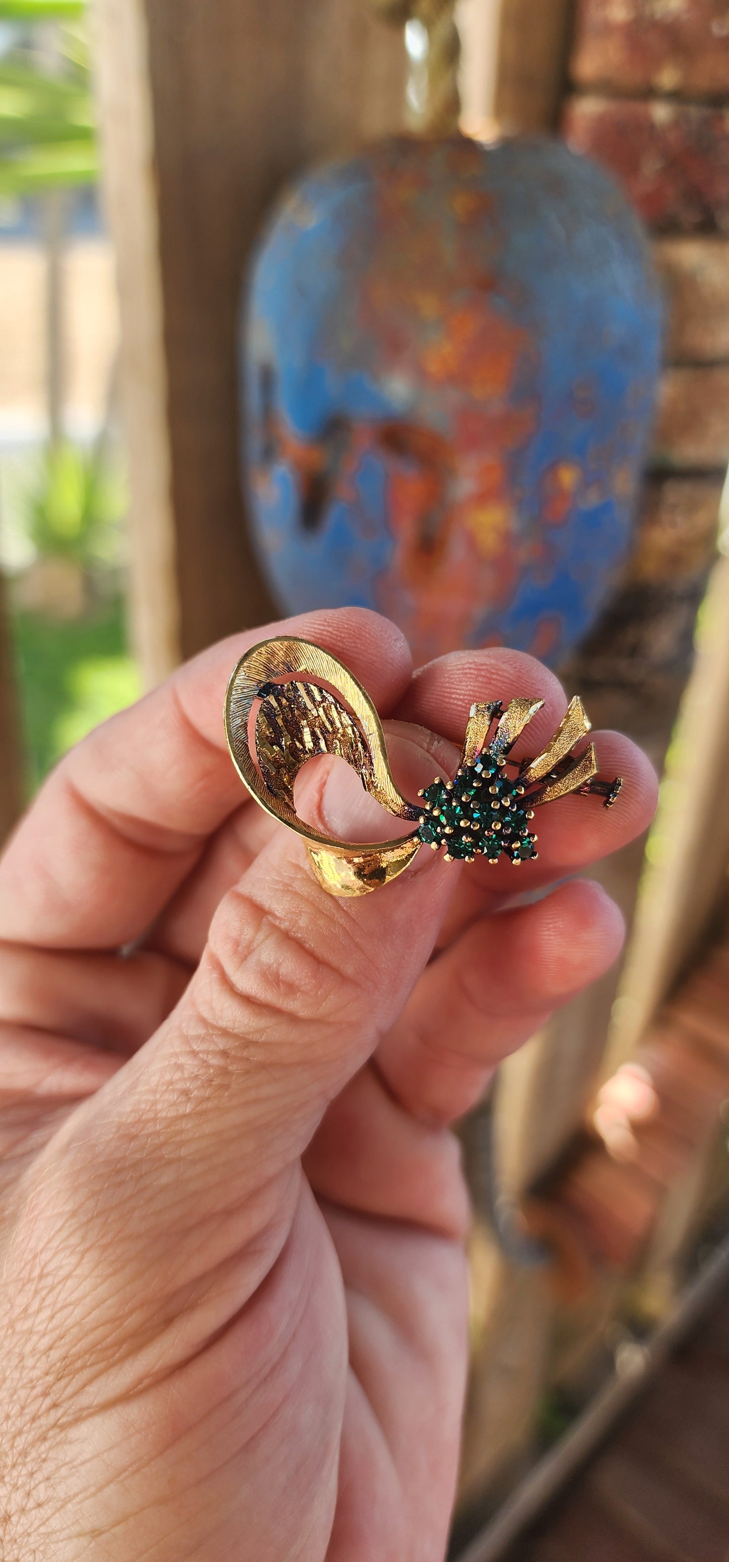 This brooch is a stunning example of mid-century modernist elegance with a bold yet graceful design. Crafted in sterling silver with an opulent yellow gold plating, it features a dynamic, fluid form—almost like a ribbon caught mid-sway, frozen in a moment