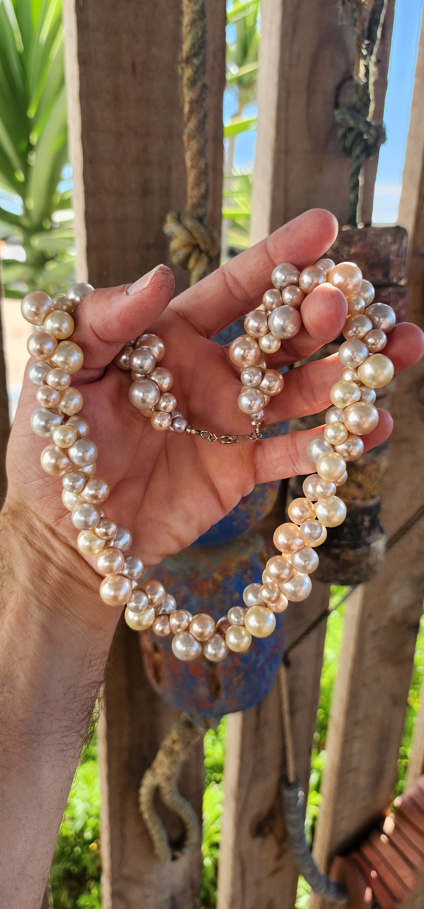 This playful vintage 1980s faux pearl necklace is what happens when elegance decides to let its hair down and throw a garden party! Featuring a joyous jumble of creamy vanilla, dreamy dove-grey, and soft peach faux pearls.