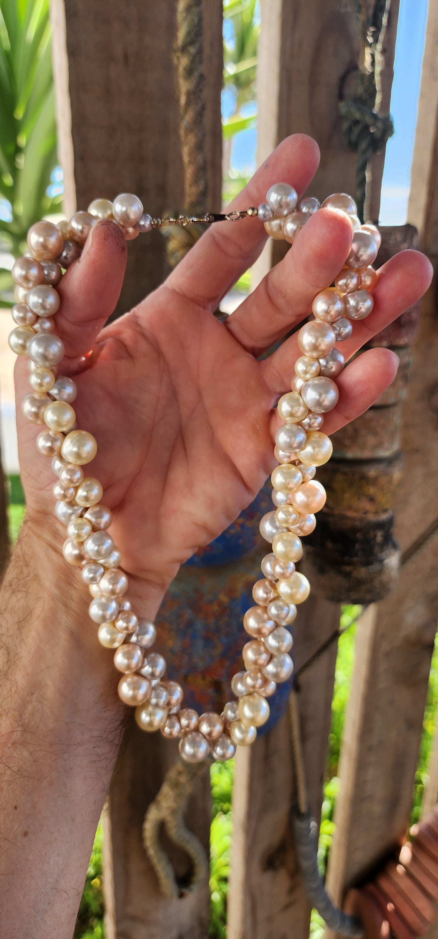 This playful vintage 1980s faux pearl necklace is what happens when elegance decides to let its hair down and throw a garden party! Featuring a joyous jumble of creamy vanilla, dreamy dove-grey, and soft peach faux pearls.