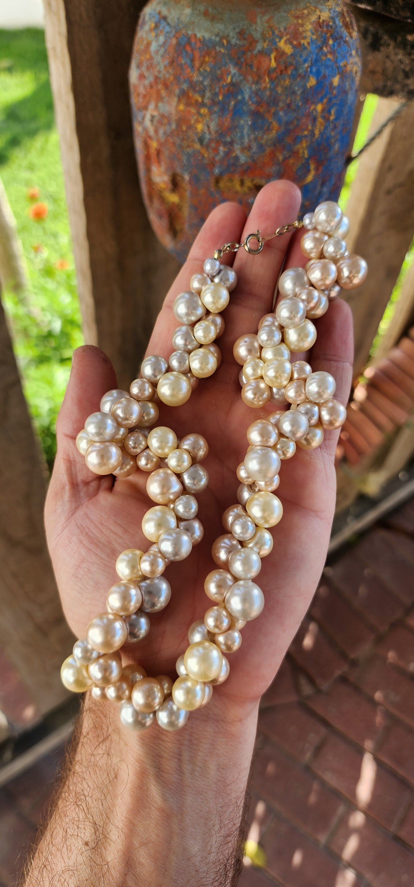 This playful vintage 1980s faux pearl necklace is what happens when elegance decides to let its hair down and throw a garden party! Featuring a joyous jumble of creamy vanilla, dreamy dove-grey, and soft peach faux pearls.