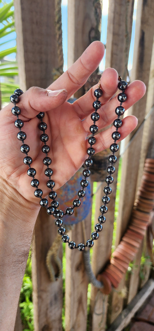 This necklace is giving vintage mystery with a touch of rockstar cool. Extra long, sultry strand of glossy hematite gemstone beads—perfectly round, highly polished, and dark as a midnight mirror.