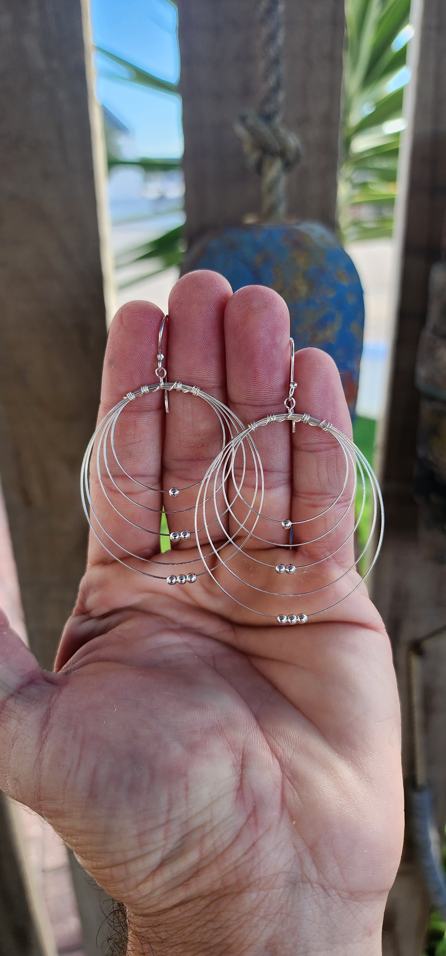These sculptural stunners are a kinetic dream in sterling silver. Like minimalist mobiles plucked straight from a Calder sketch, each earring features five progressively sized, ultra-fine wire hoops nested within one another, curving in perfect harmony.