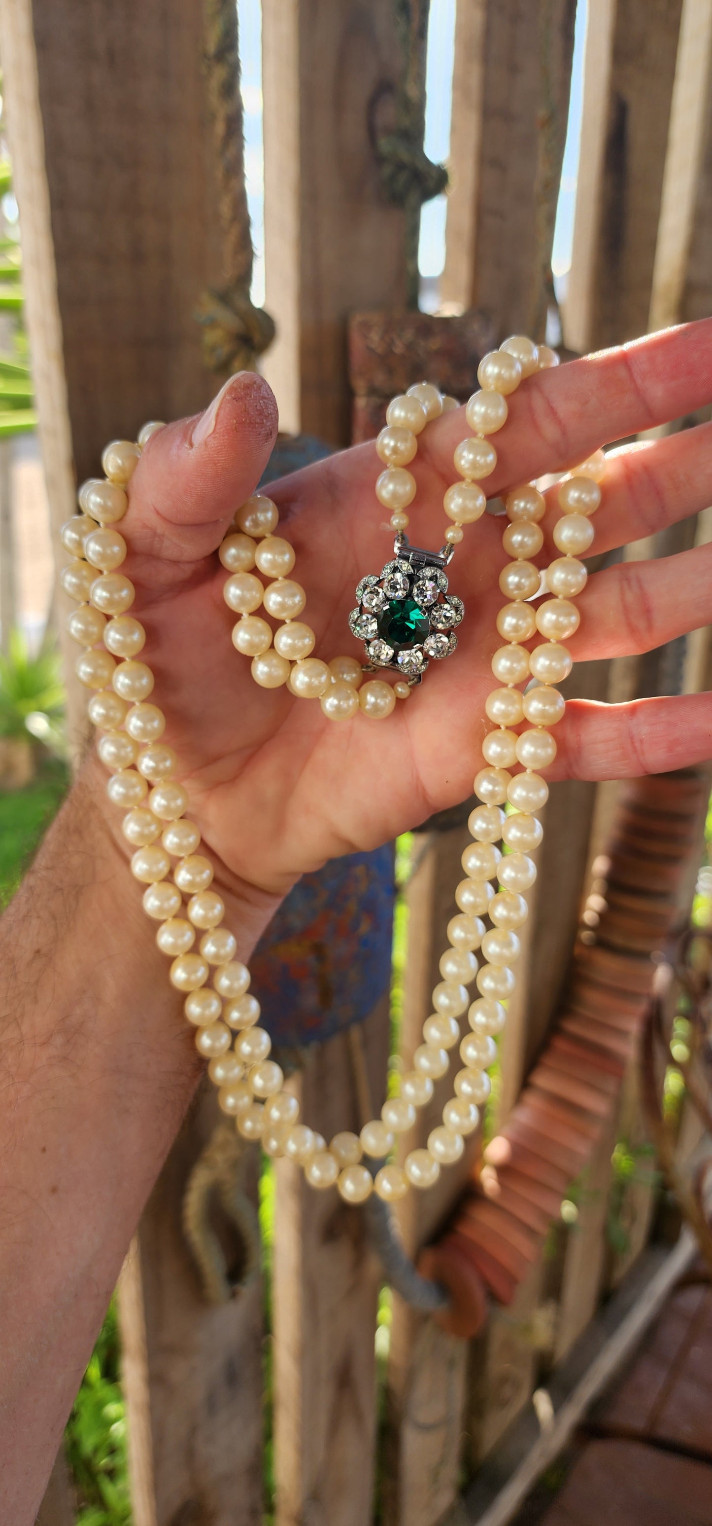 This fabulous Art Deco-era double strand costume necklace, dating to the glitzy 1940s, is pure vintage elegance with a side of silver screen sparkle. The strands are composed of rich, creamy glass faux pearls, each one lovingly hand-knotted.