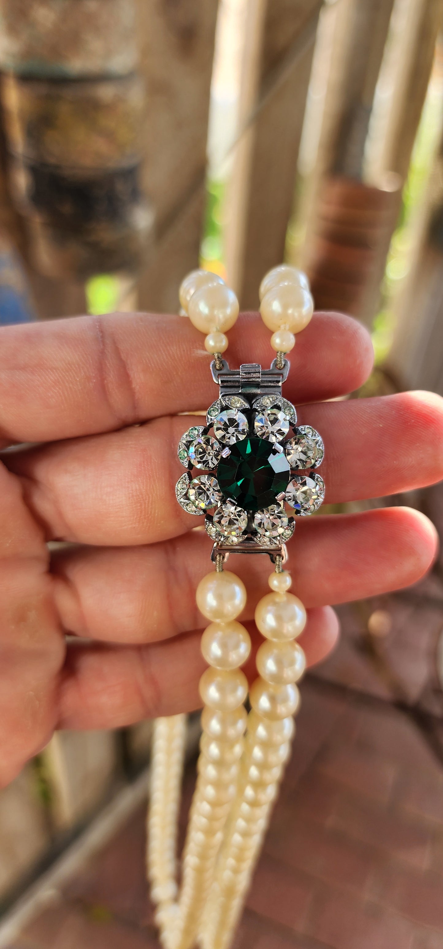 This fabulous Art Deco-era double strand costume necklace, dating to the glitzy 1940s, is pure vintage elegance with a side of silver screen sparkle. The strands are composed of rich, creamy glass faux pearls, each one lovingly hand-knotted.