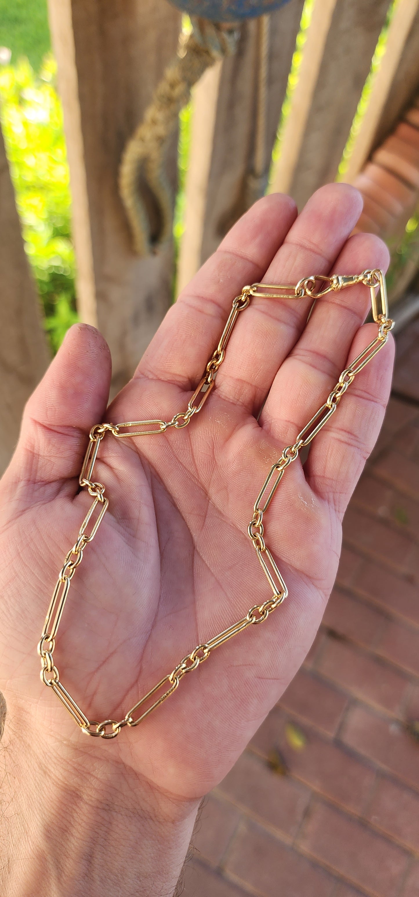 Say hello to a slice of wearable history — a fabulous antique fob chain that marries timeless sophistication with unmistakable golden swagger.This striking beauty is composed entirely of solid 18ct buttery yellow gold.