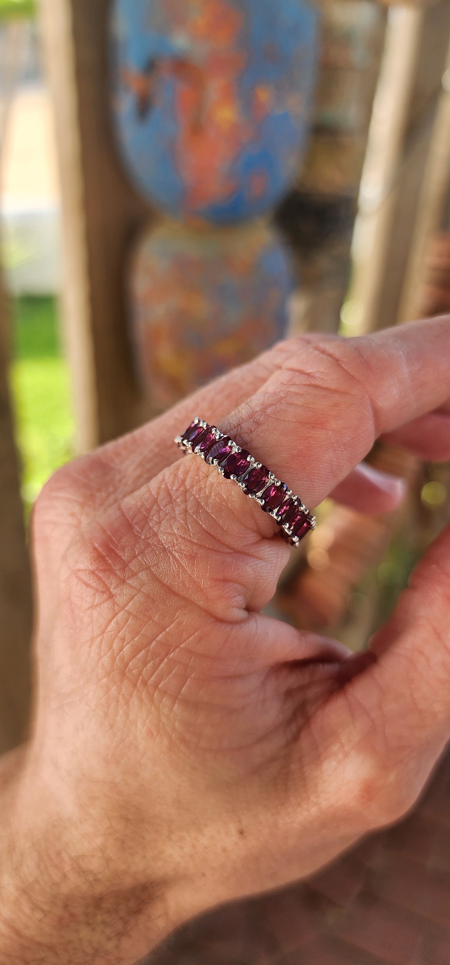 This sterling silver full eternity ring is a dazzling display of deep, rich purple rhodolite garnets, meticulously claw-set in an endless circle of brilliance.