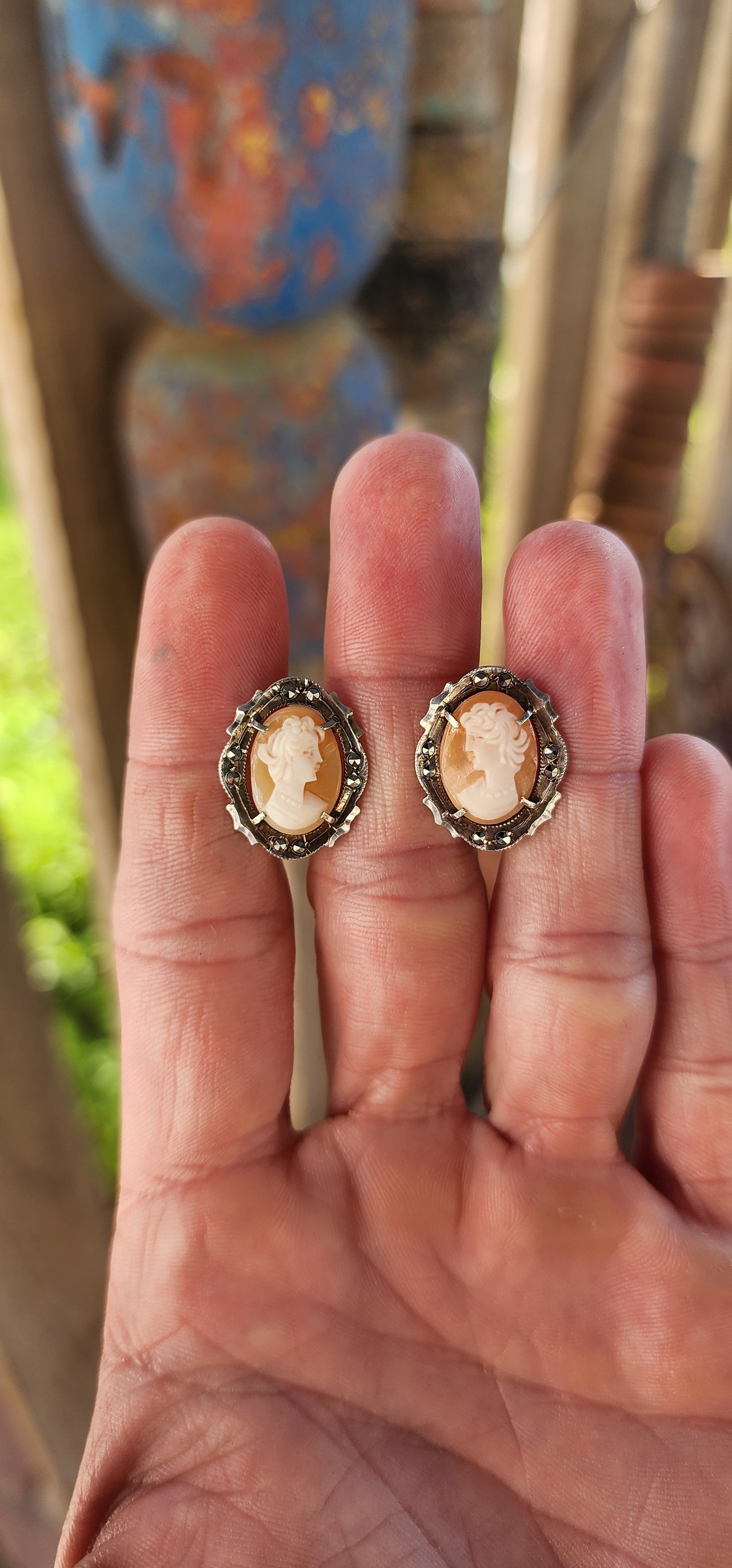A pair of vintage Italian 800 Silver and Conch Shell Cameo Clip-On Earrings, Circa 1940's.
Gracefully embodying the timeless elegance of Belle Époque refinement, this exquisite pair of vintage earrings is a masterclass in classical ornamentation.