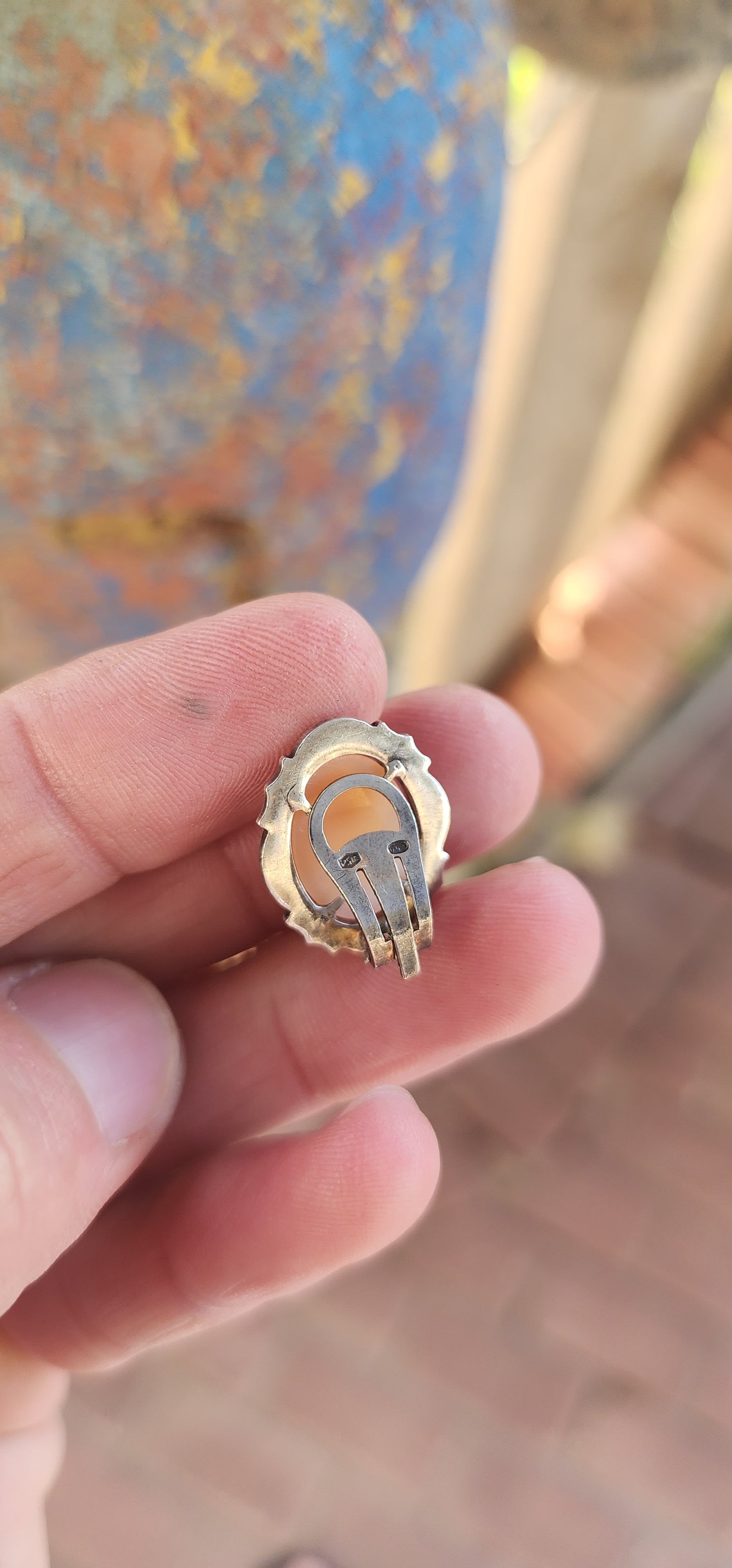 A pair of vintage Italian 800 Silver and Conch Shell Cameo Clip-On Earrings, Circa 1940's.
Gracefully embodying the timeless elegance of Belle Époque refinement, this exquisite pair of vintage earrings is a masterclass in classical ornamentation.