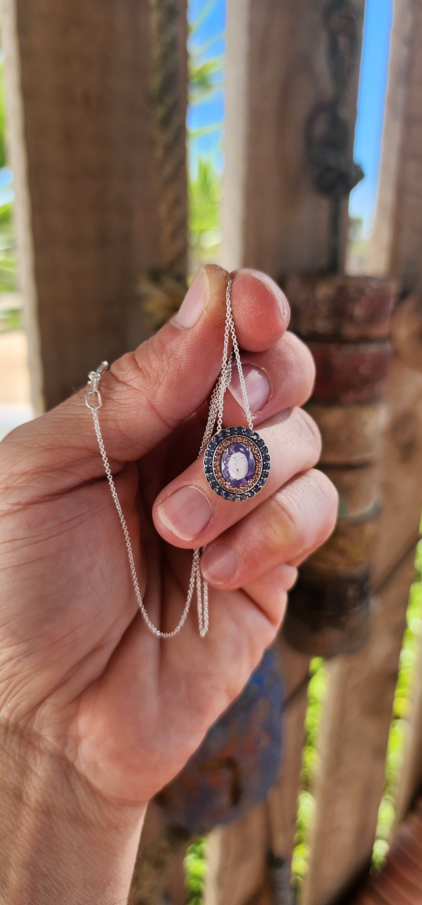 This sterling silver pendant is pure twilight magic captured in a frame of fire and midnight.
