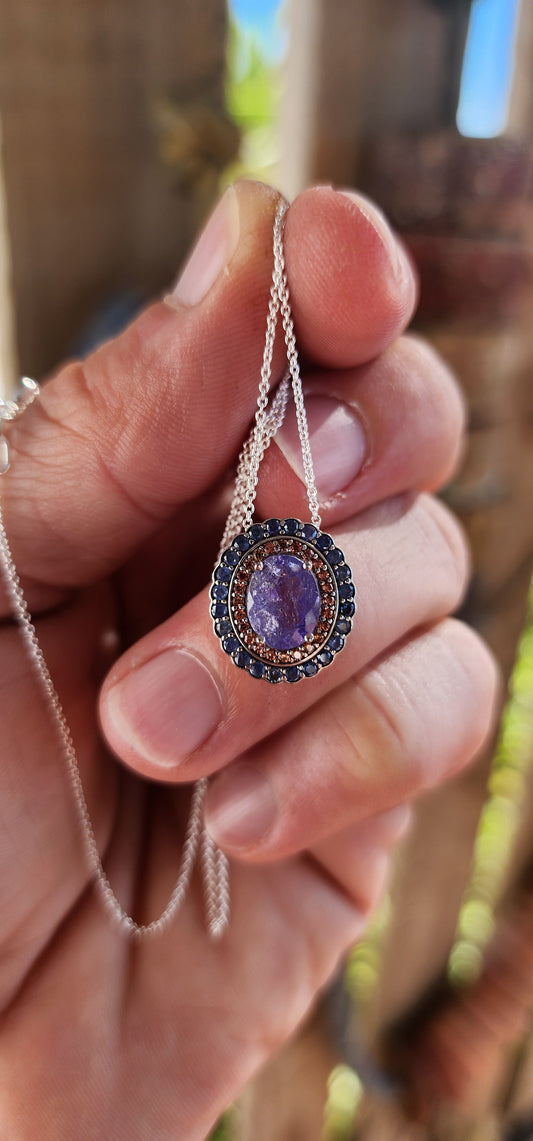 This sterling silver pendant is pure twilight magic captured in a frame of fire and midnight.