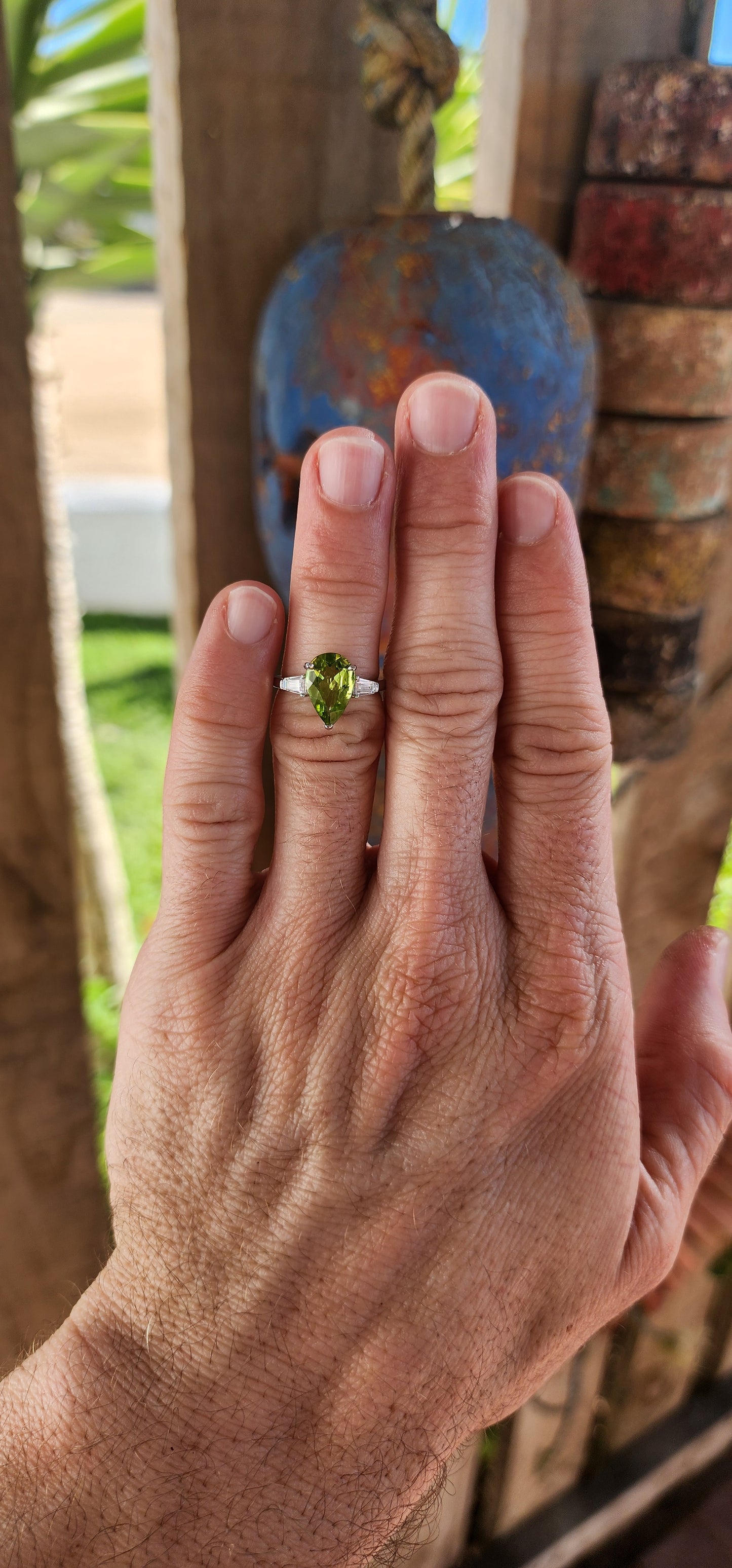 Say hello to this bold beauty — a sterling silver trilogy ring that’s practically glowing with zest and charm!
At its heart lies a mesmerizing, generously sized pear-cut peridot, gleaming in a vivid lime-green hue.