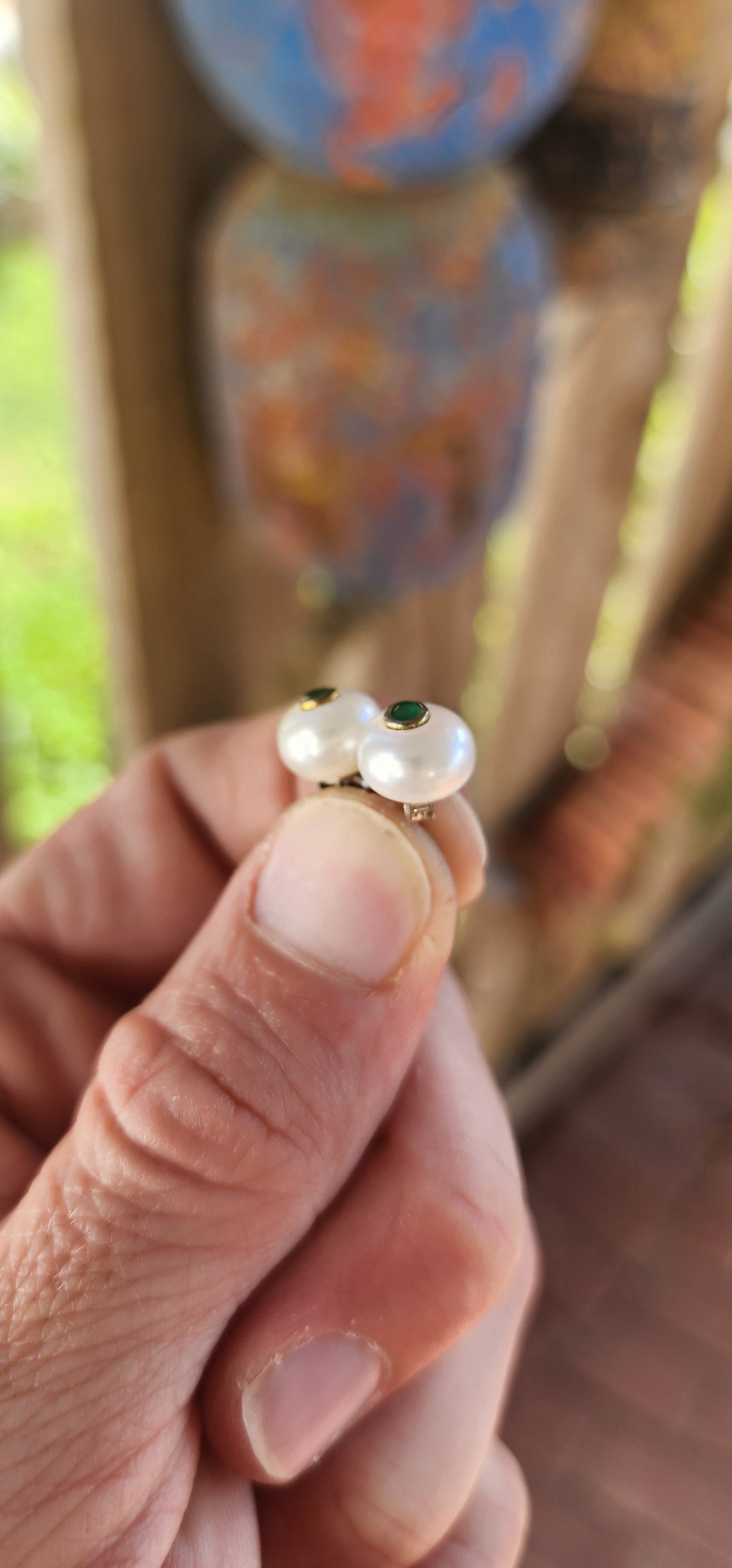 Add a dash of magic and a royal whisper of emerald enchantment with these captivating faux emerald and pearl stud earrings! Like tiny orbs of moonlight kissed by spring forests.
