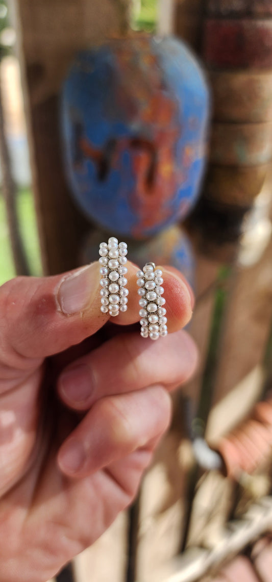 Say hello to your new lobes' favorite party guests—these fabulous freshwater pearl huggies!