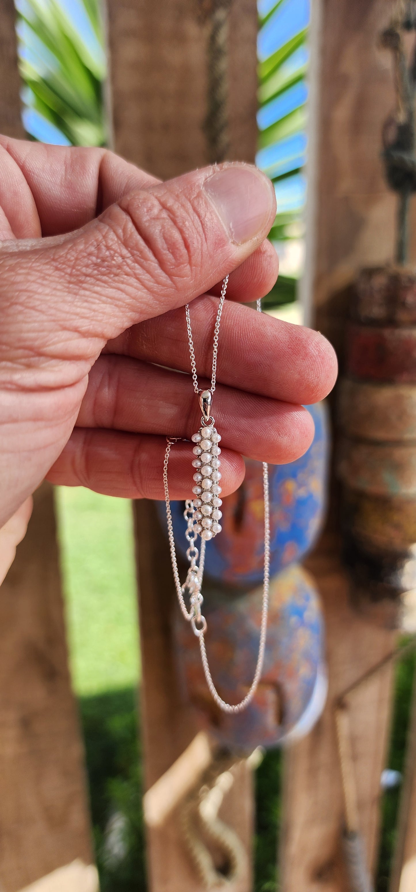 Drizzling elegance straight down your neckline, this sterling silver beauty is all about pearly perfection with a twist.
