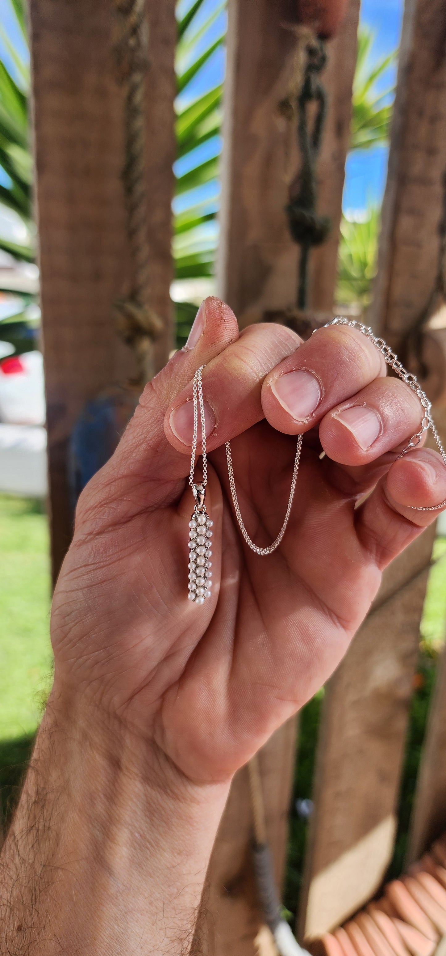 Drizzling elegance straight down your neckline, this sterling silver beauty is all about pearly perfection with a twist.