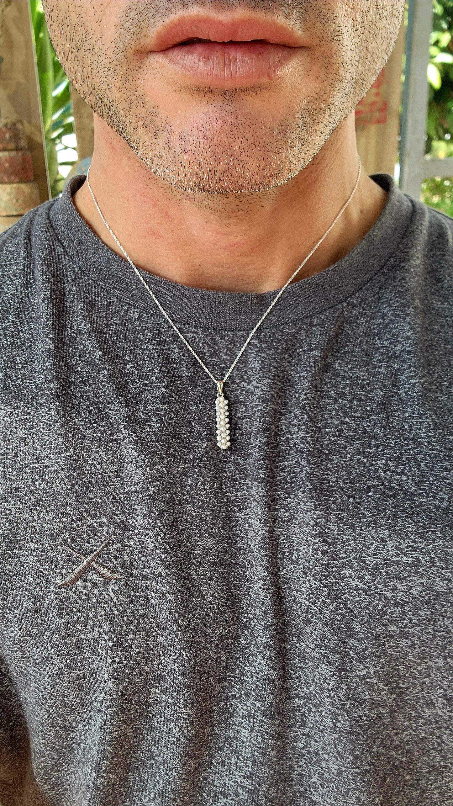 Drizzling elegance straight down your neckline, this sterling silver beauty is all about pearly perfection with a twist.