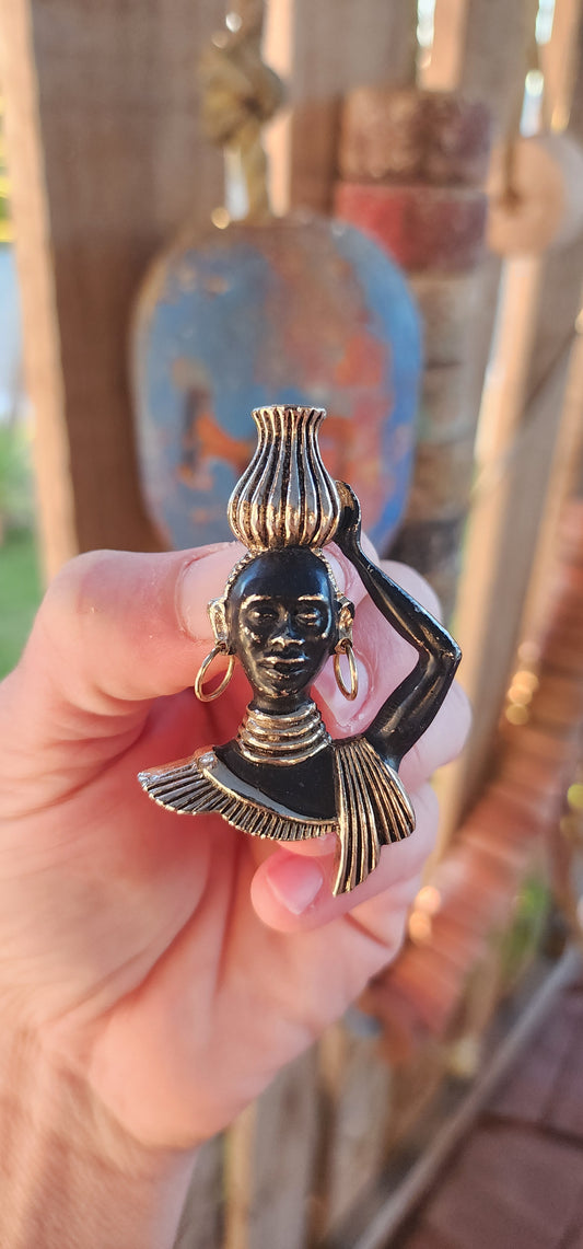 This 1950/60s mid-century costume brooch is all about bold storytelling, cultural homage, and theatrical flair! Crafted in goldtone brass with hand-applied cold-painted black enamel, this figural masterpiece depicts a poised Nubian water carrier.